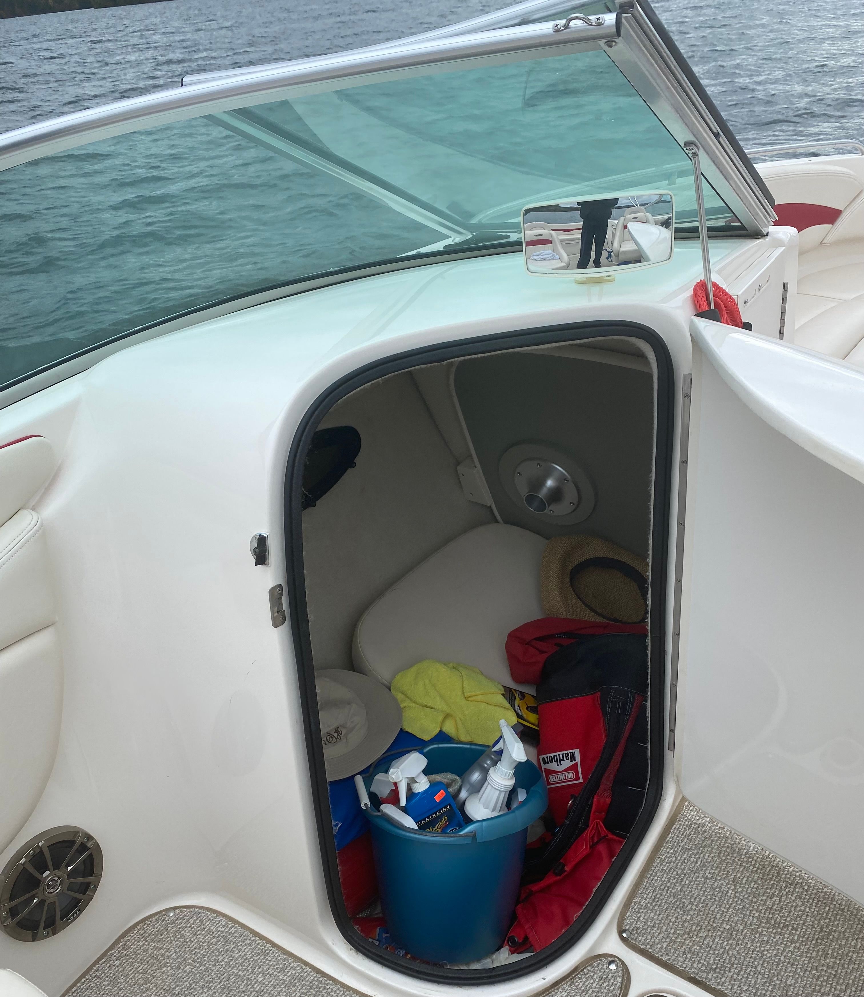 Storage compartment in Chaparral 230 SSi boat with cleaning supplies.