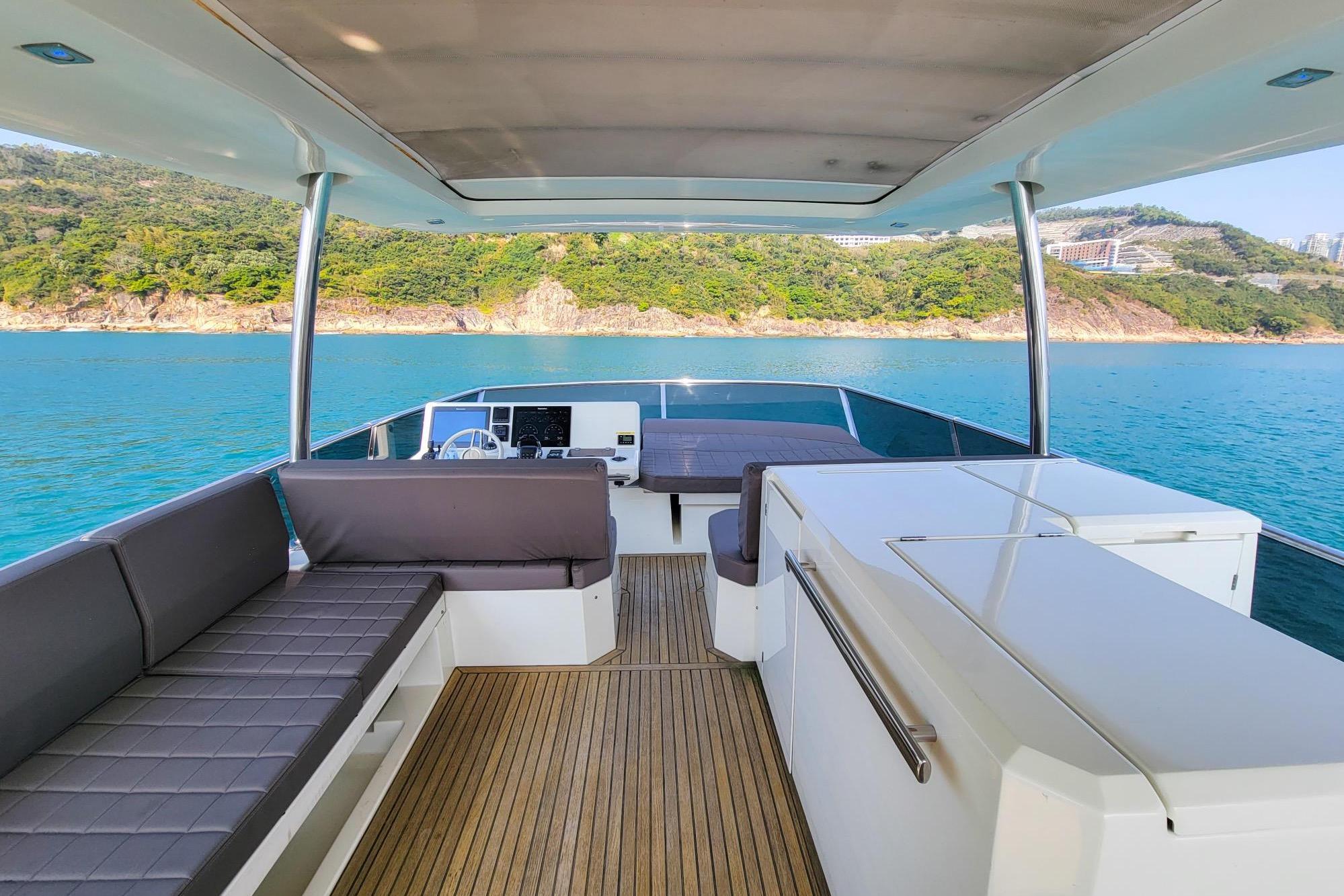 Luxurious 2019 Prestiage 630 yacht interior with scenic ocean view and modern seating.