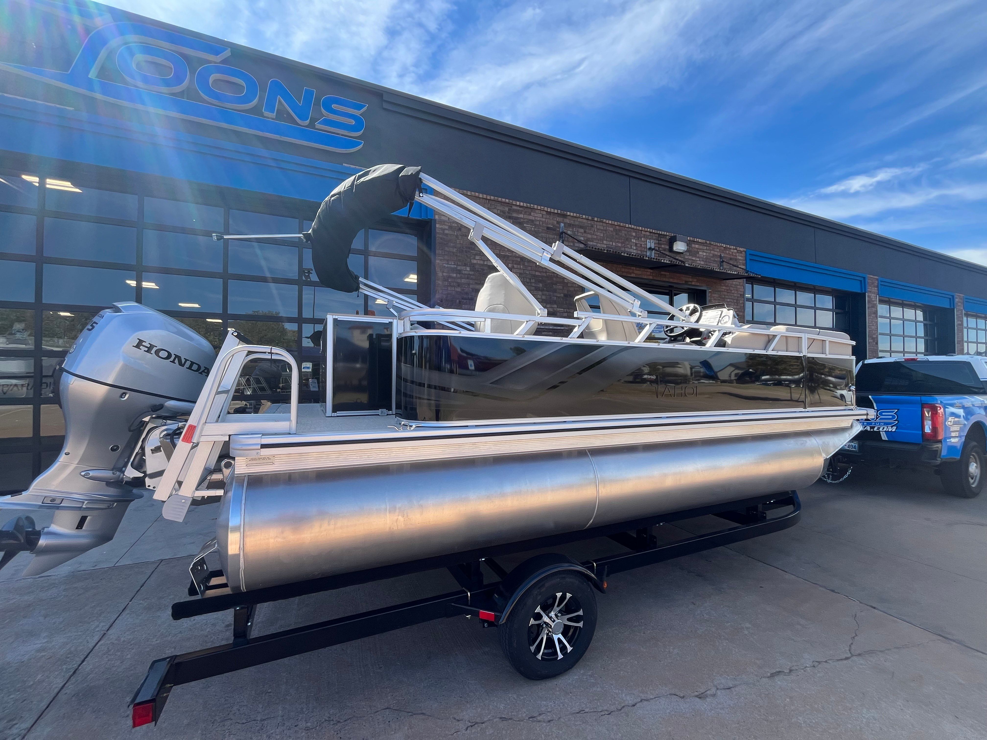 2026 Tahoe 1925 Sport Rear Fish boat outside a store.