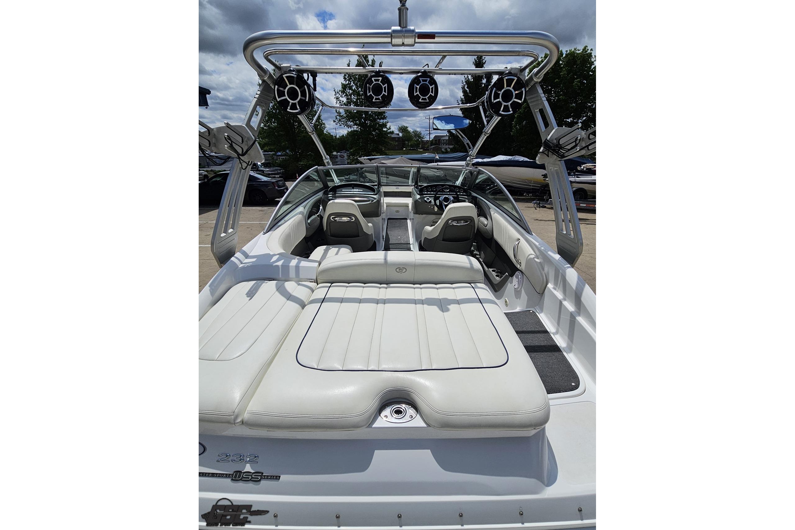 2010 Cobalt 232 WSS boat interior with white seating and wakeboard tower.