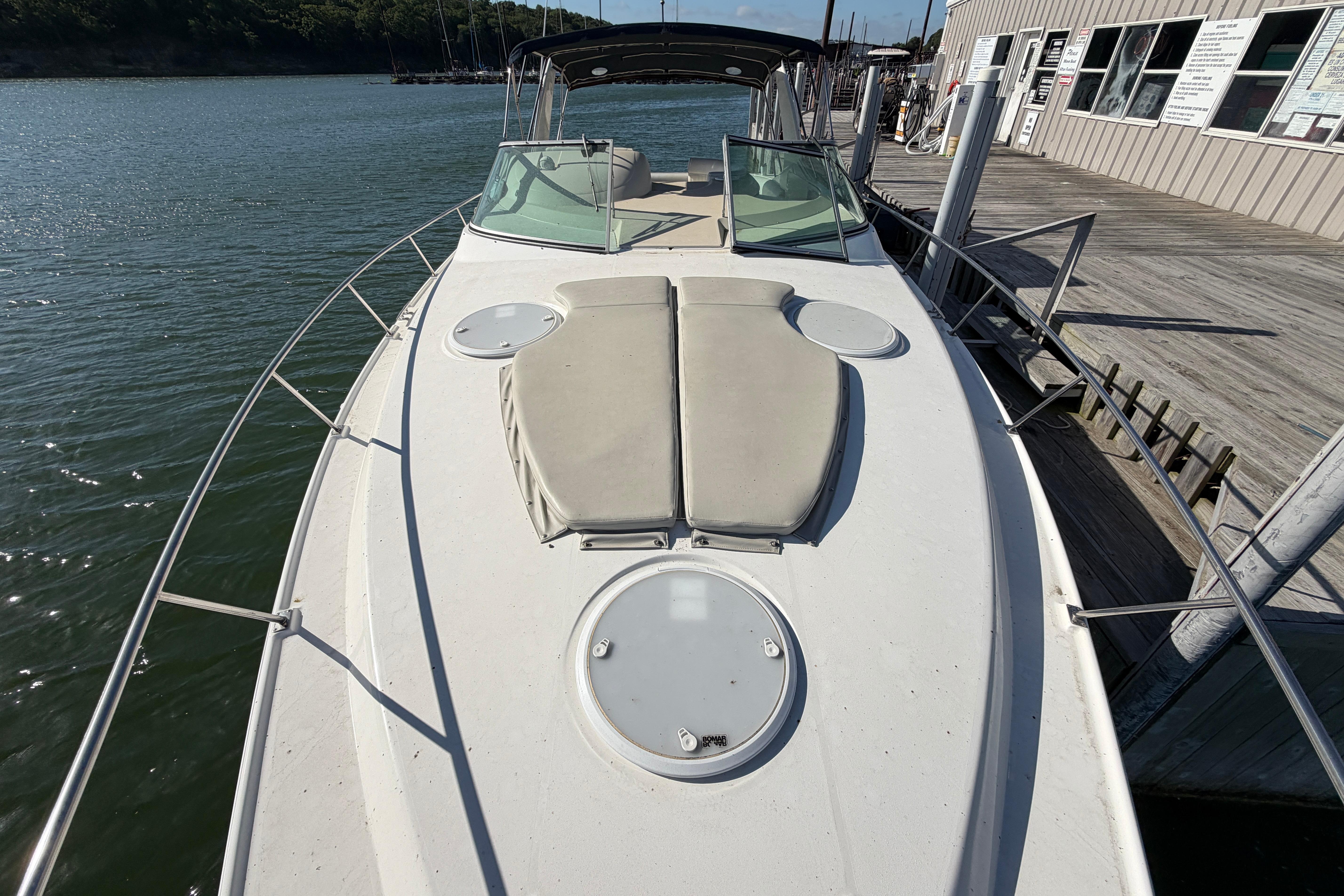 1997 Cruisers 3575 yacht docked, featuring spacious deck and sleek design.