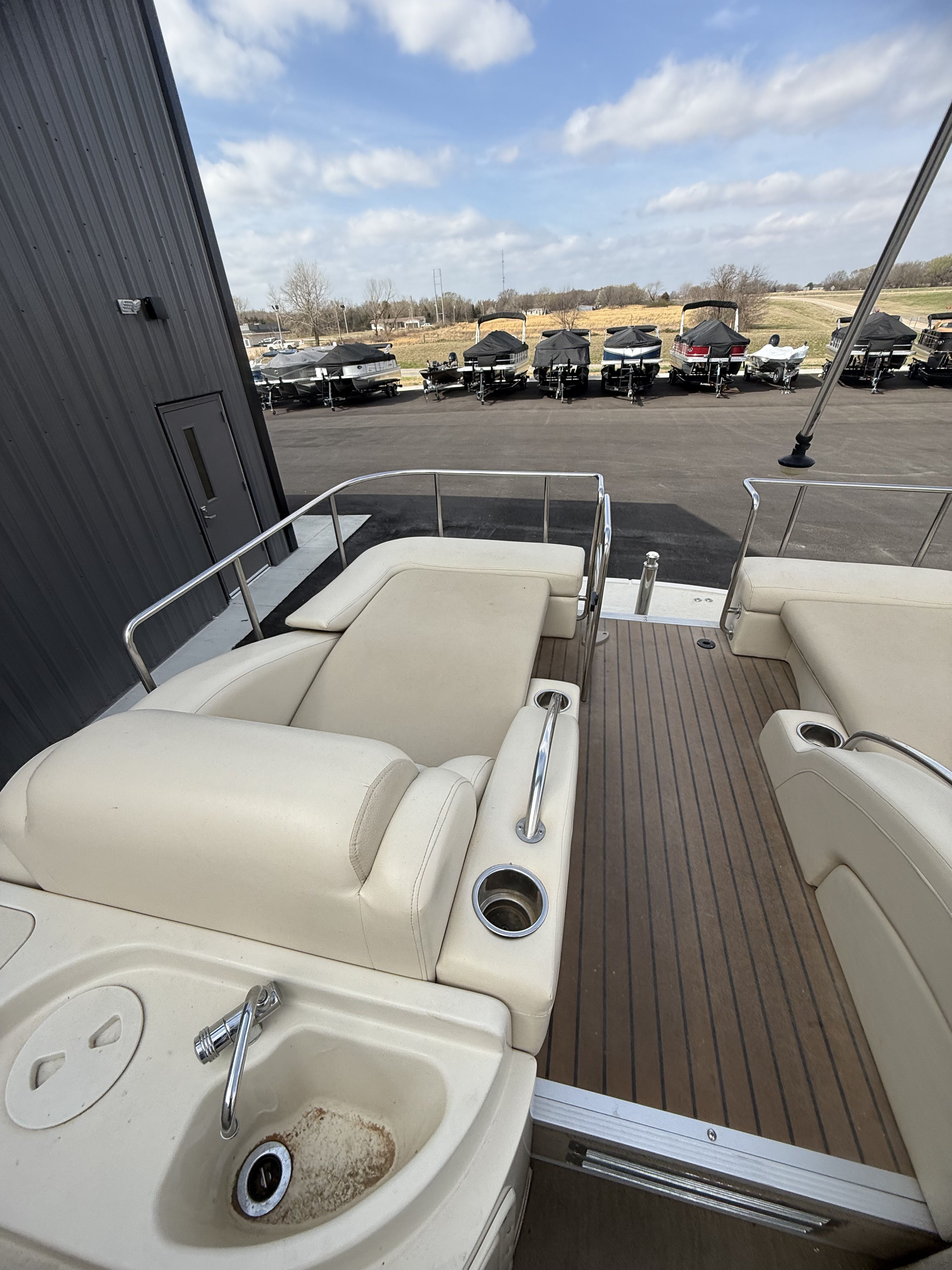 Interior of a 2014 Bennington 2575RCW-I/O pontoon boat with seating area.