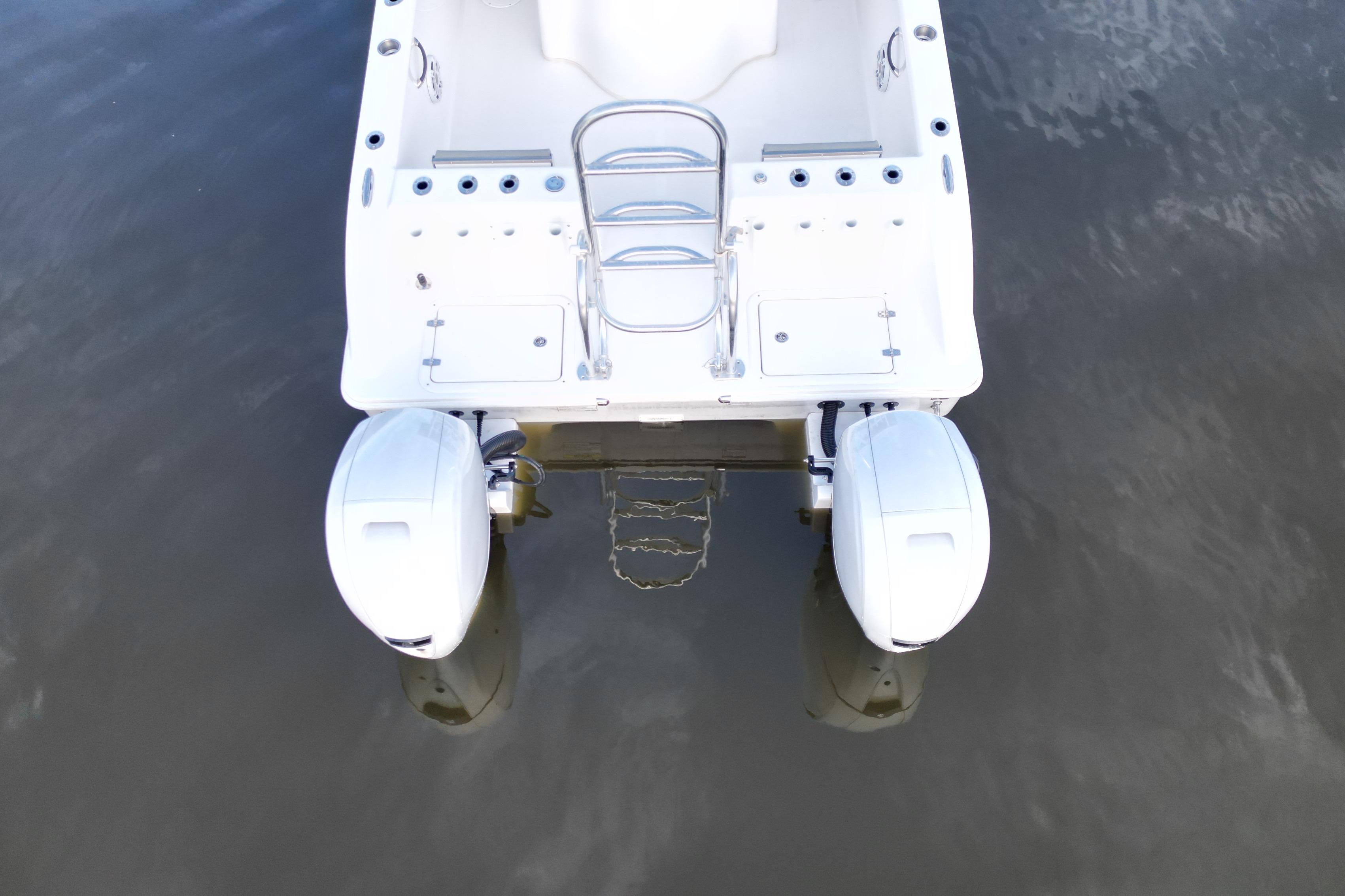 2023 Twin Vee 260 GFX CC boat with dual outboard motors on calm water.