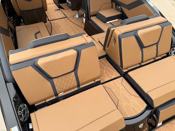 2025 Yamaha Boats 255XD interior with tan and black seating, showcasing modern design and comfort.