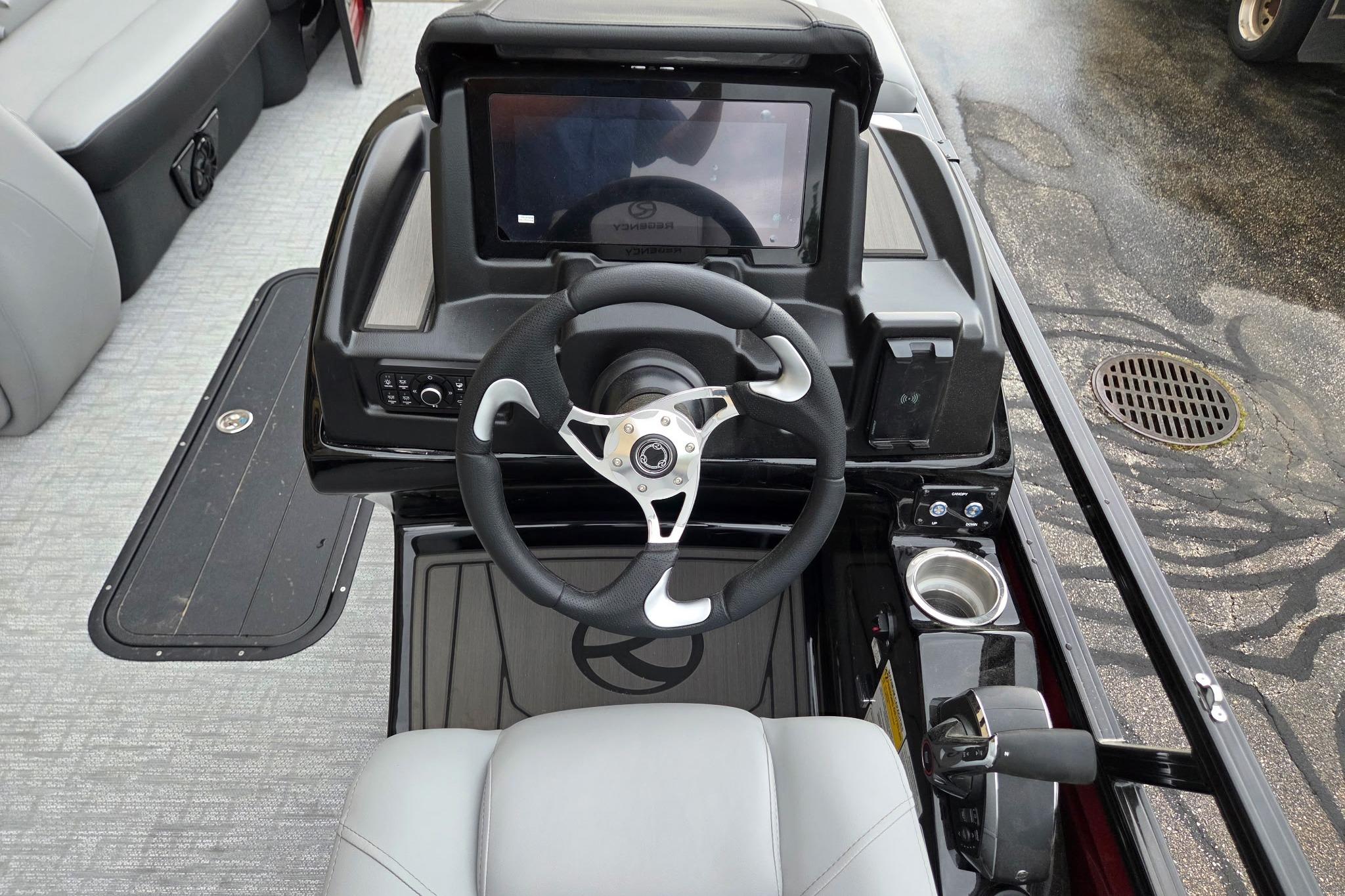Steering console of 2026 Regency 230 DL boat with modern controls and touchscreen display.