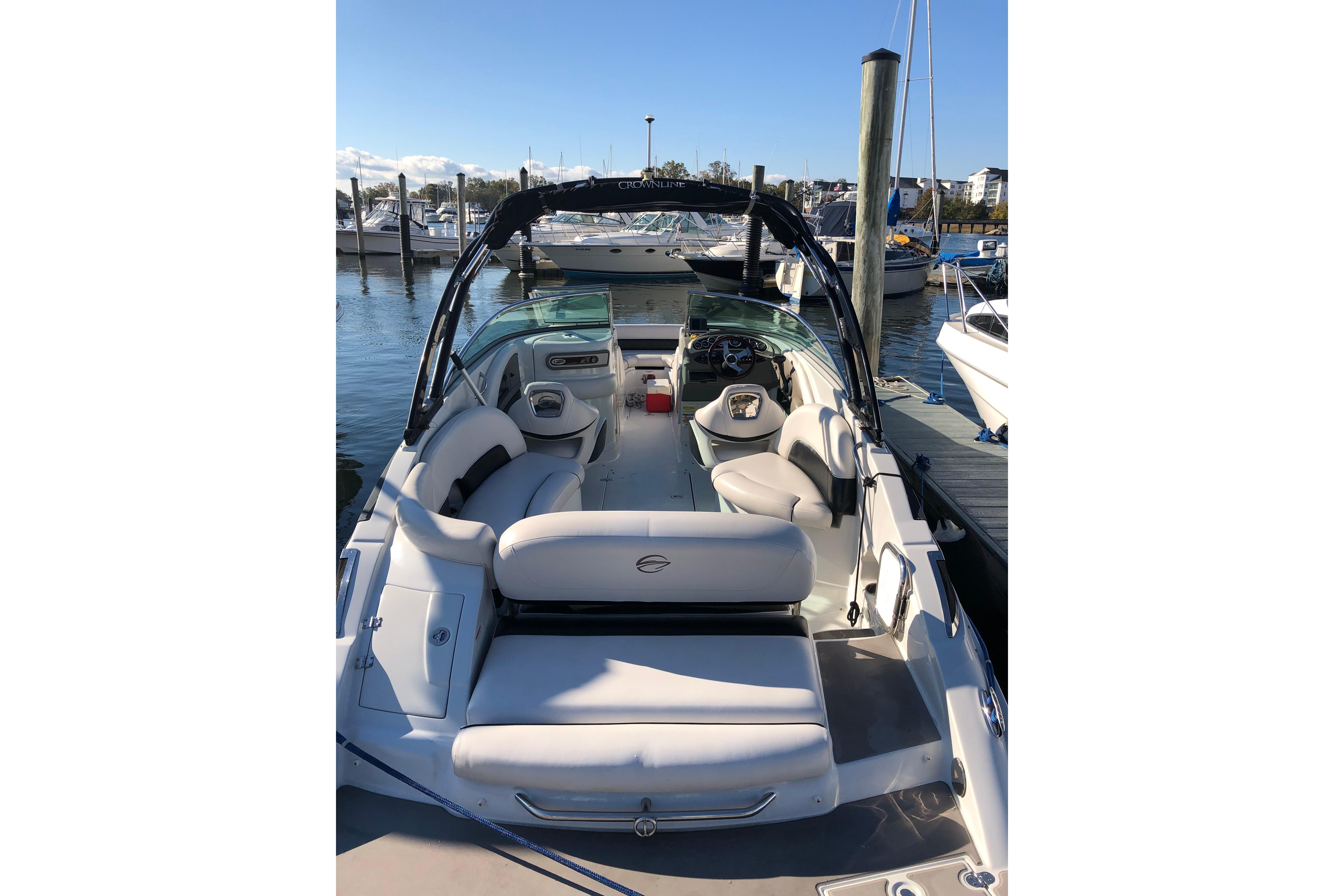 2013 Crownline Eclipse E4 boat docked, featuring spacious seating and sleek design.