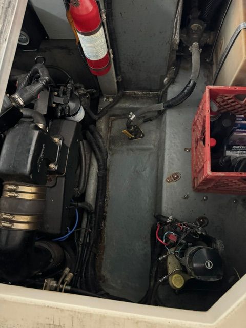 Engine compartment of the 1992 Sea Ray 290 Sundancer with fire extinguisher and tool box.