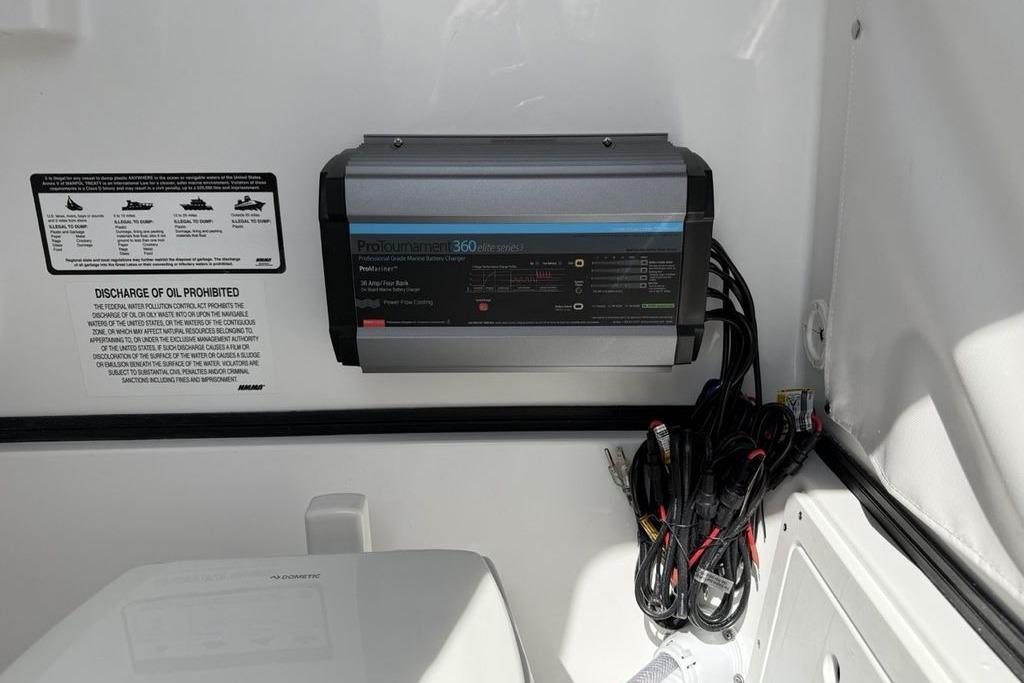 Battery charger and cables inside 2026 Sportsman Open 252 Center Console boat.