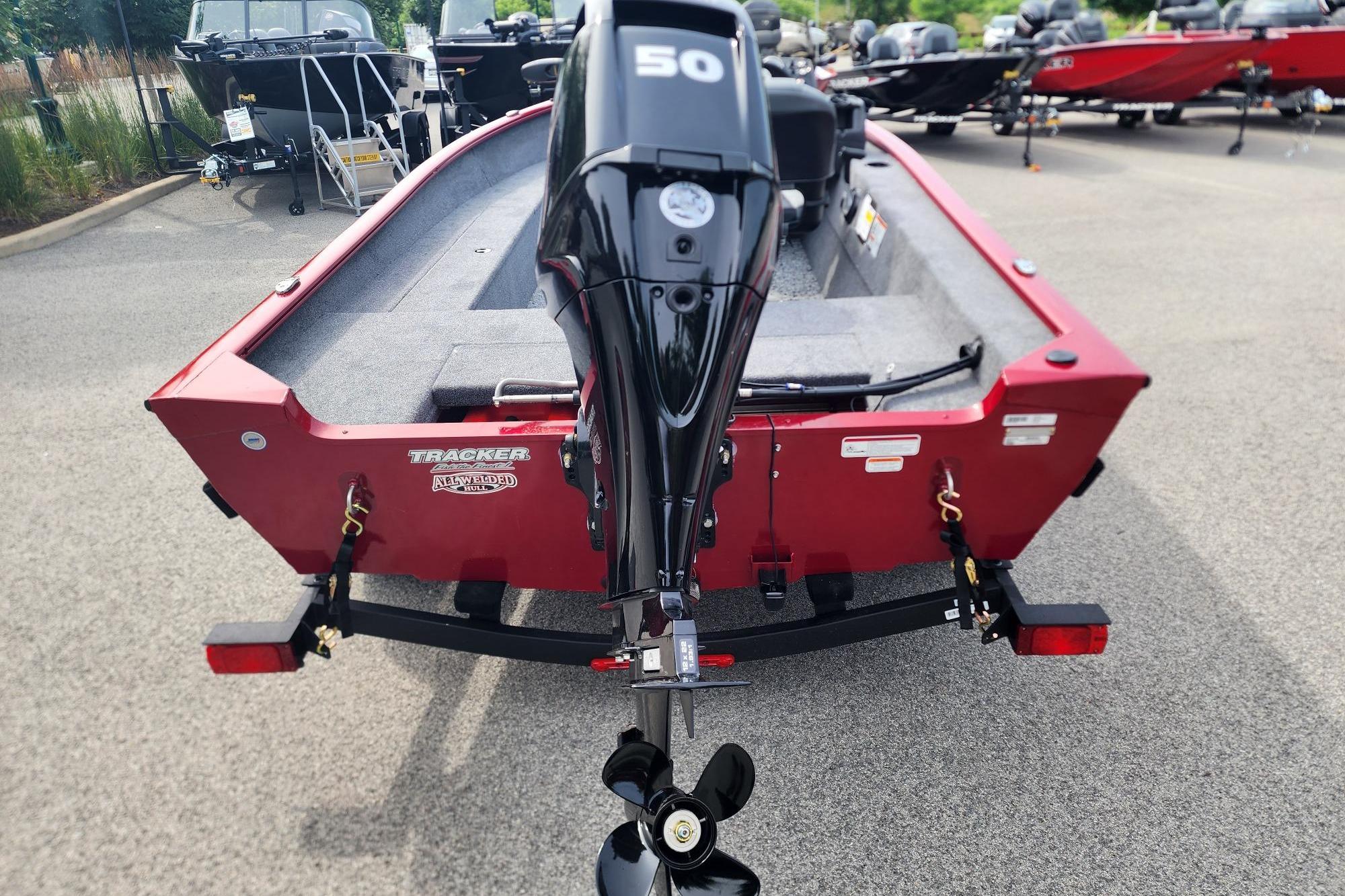 2026 Tracker Super Guide V-16 SC boat with a 50 HP motor, parked on a trailer.