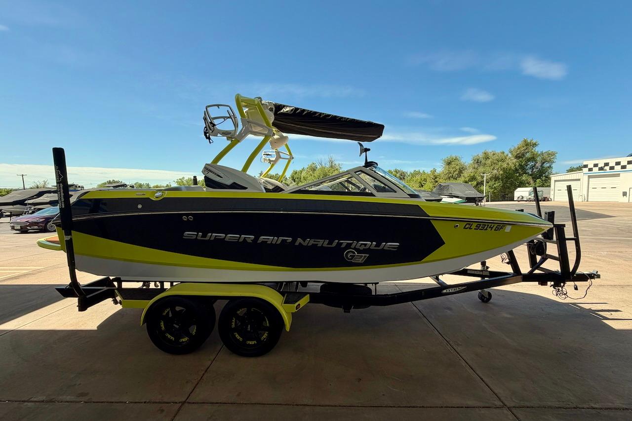 2014 Nautique Super Air Nautique G21 boat on trailer, parked outdoors.