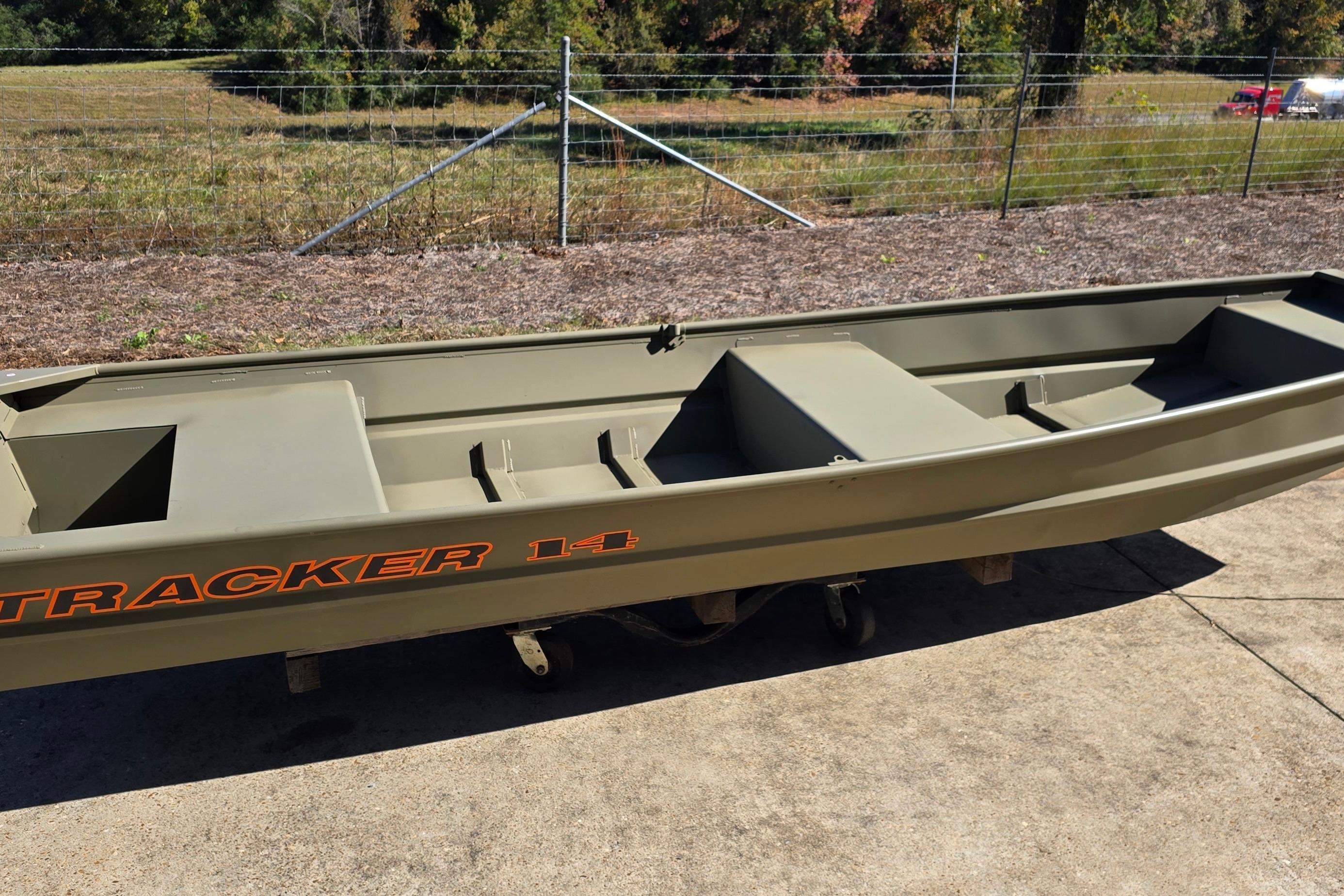 2026 Tracker Grizzly 14 Jon boat on concrete, with grassy background.