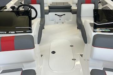 2025 Tahoe T21 boat interior with gray and red seating, modern dashboard, and spacious layout.
