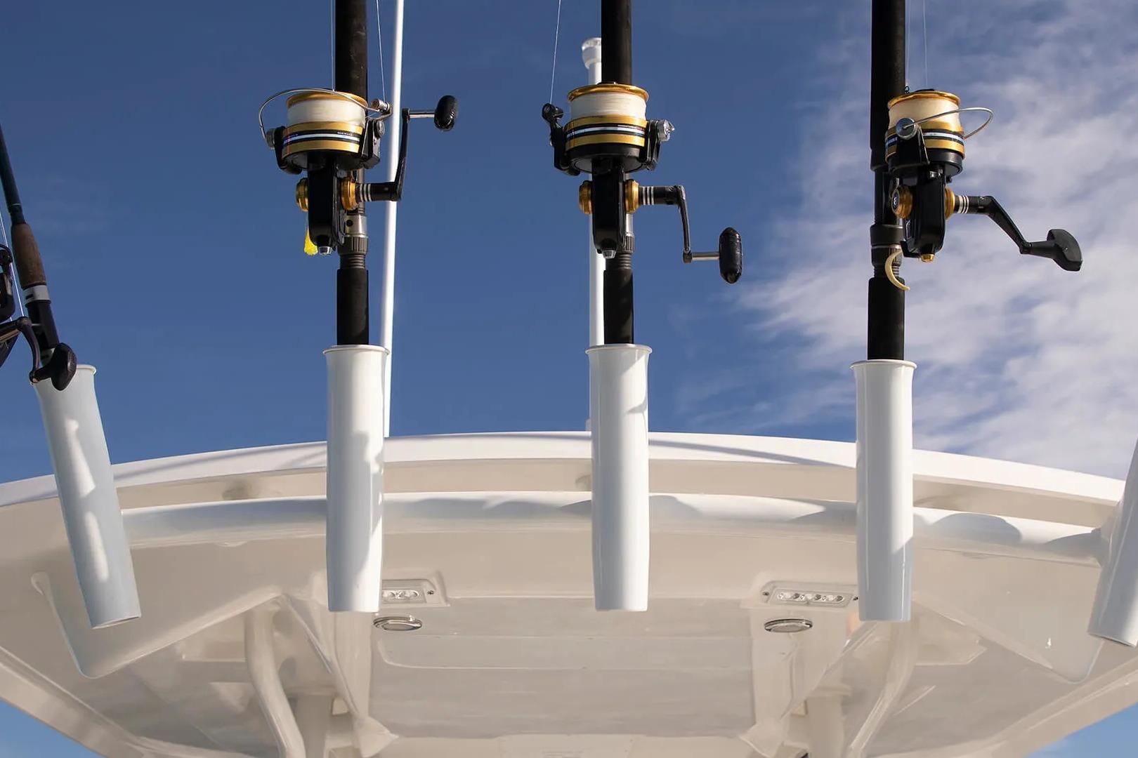 Fishing rods on a 2027 Regulator 24XO boat against a clear blue sky.