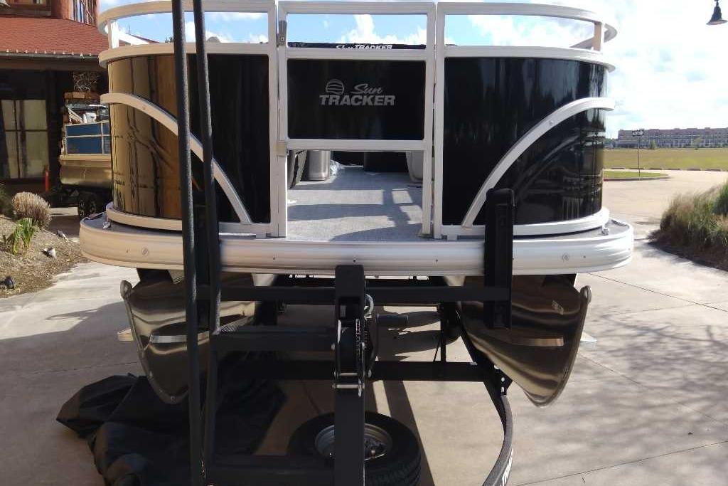 2026 Sun Tracker Fishin' Barge 22 DLX pontoon boat on trailer, rear view.