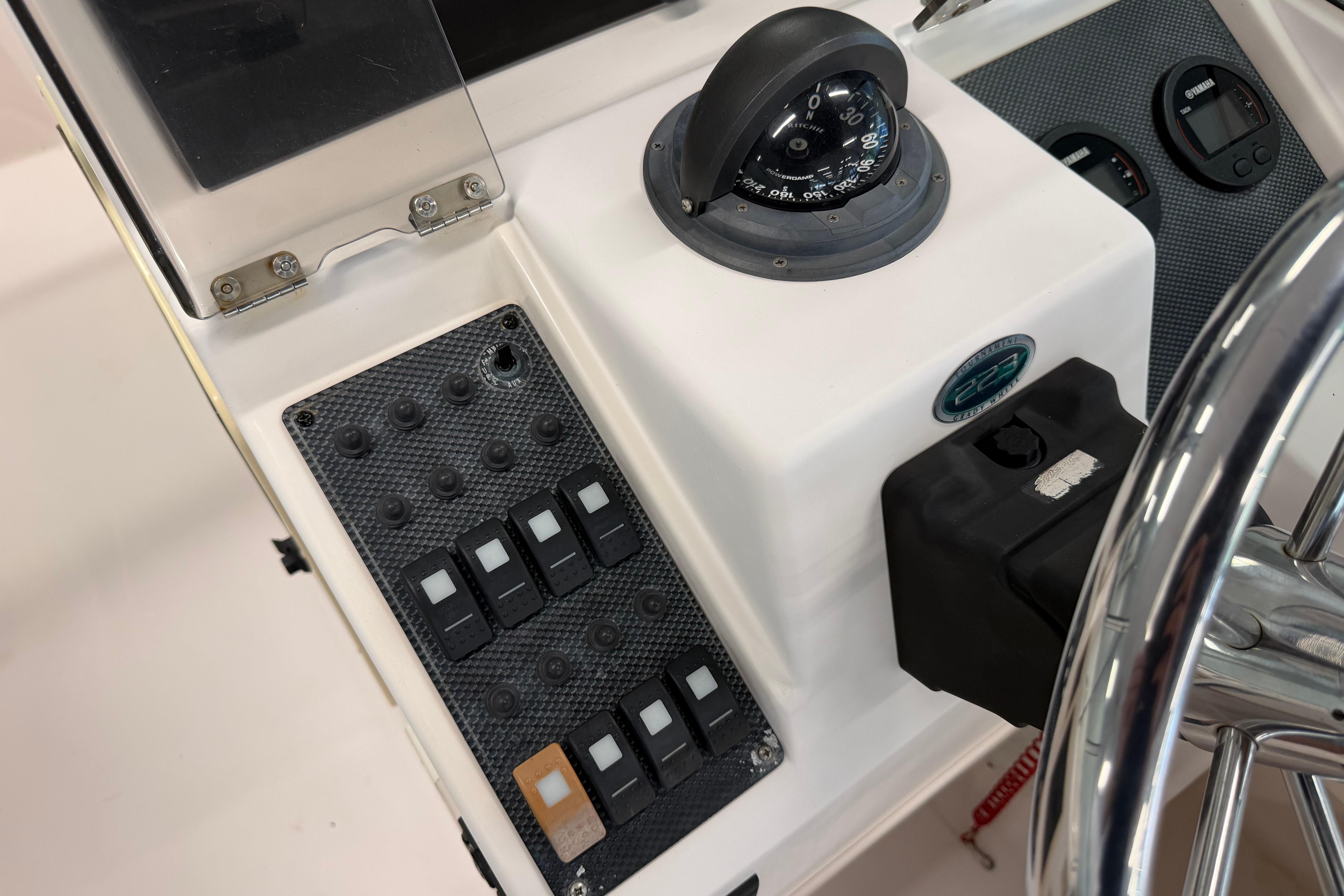 2001 Grady-White Tournament 223 boat dashboard with compass and control panel.