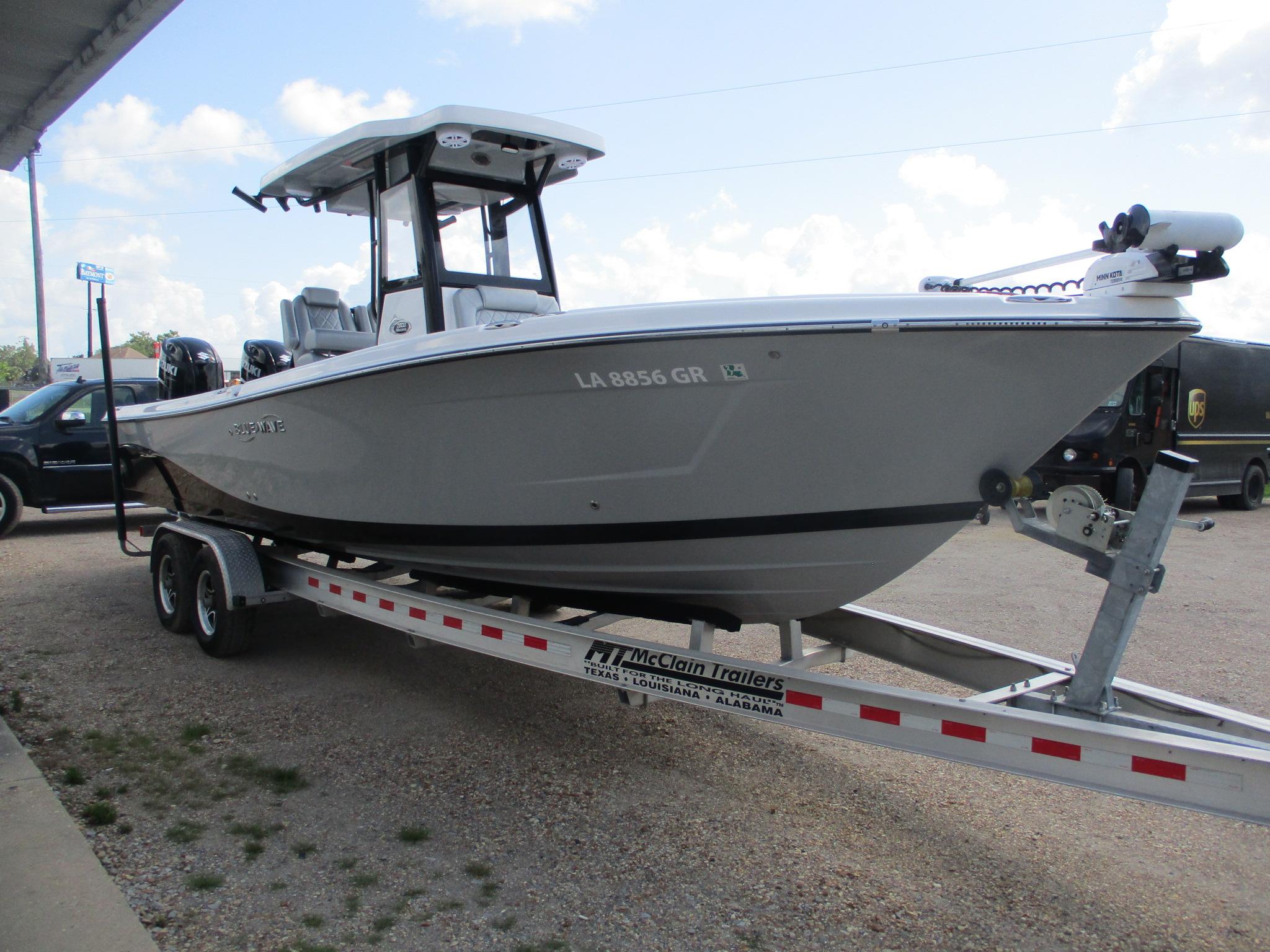 2024 Blue Wave 2800 Makaira boat on trailer, parked outdoors.