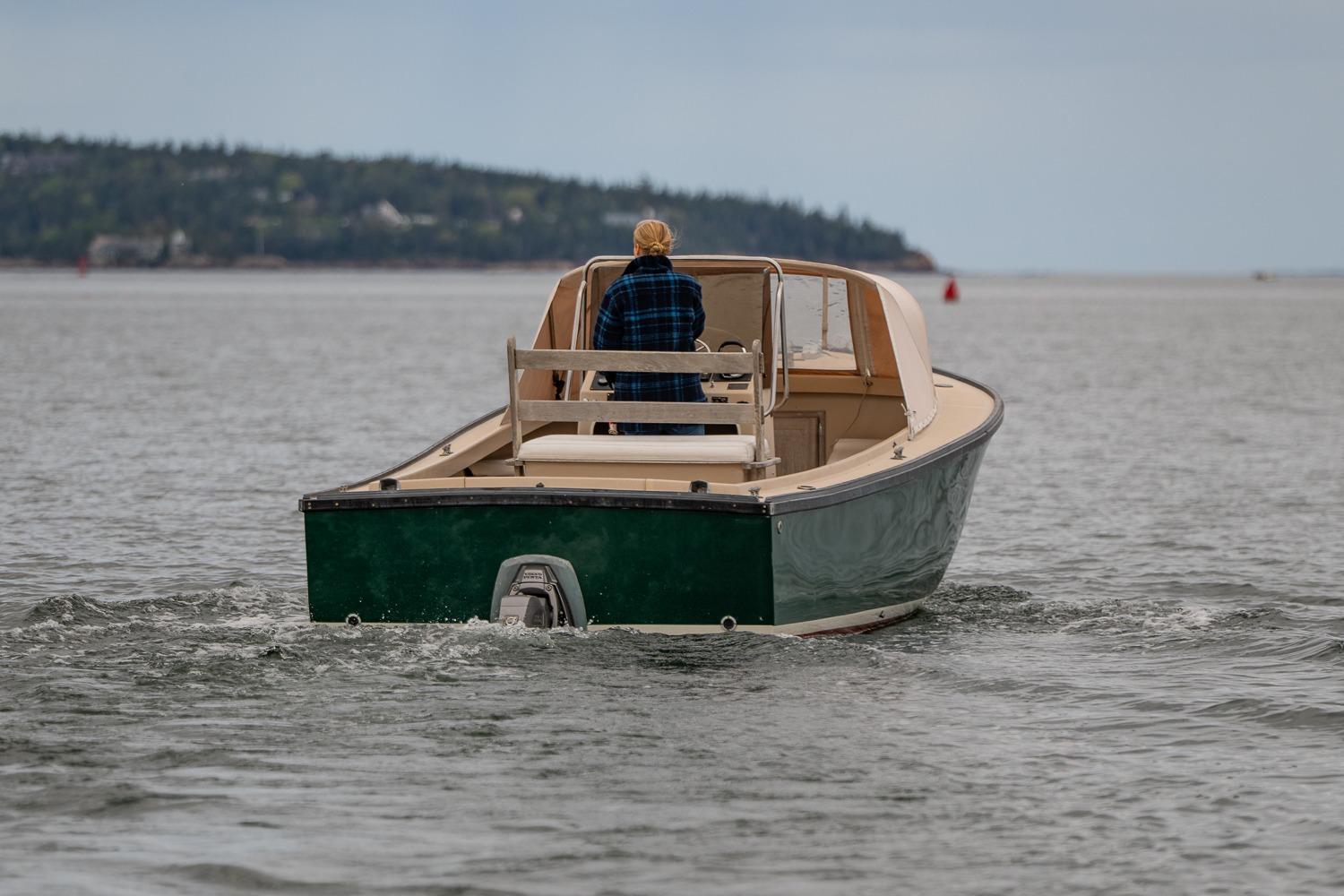 1989 Ellis 24 Open boat cruising on calm waters, distant shoreline visible.