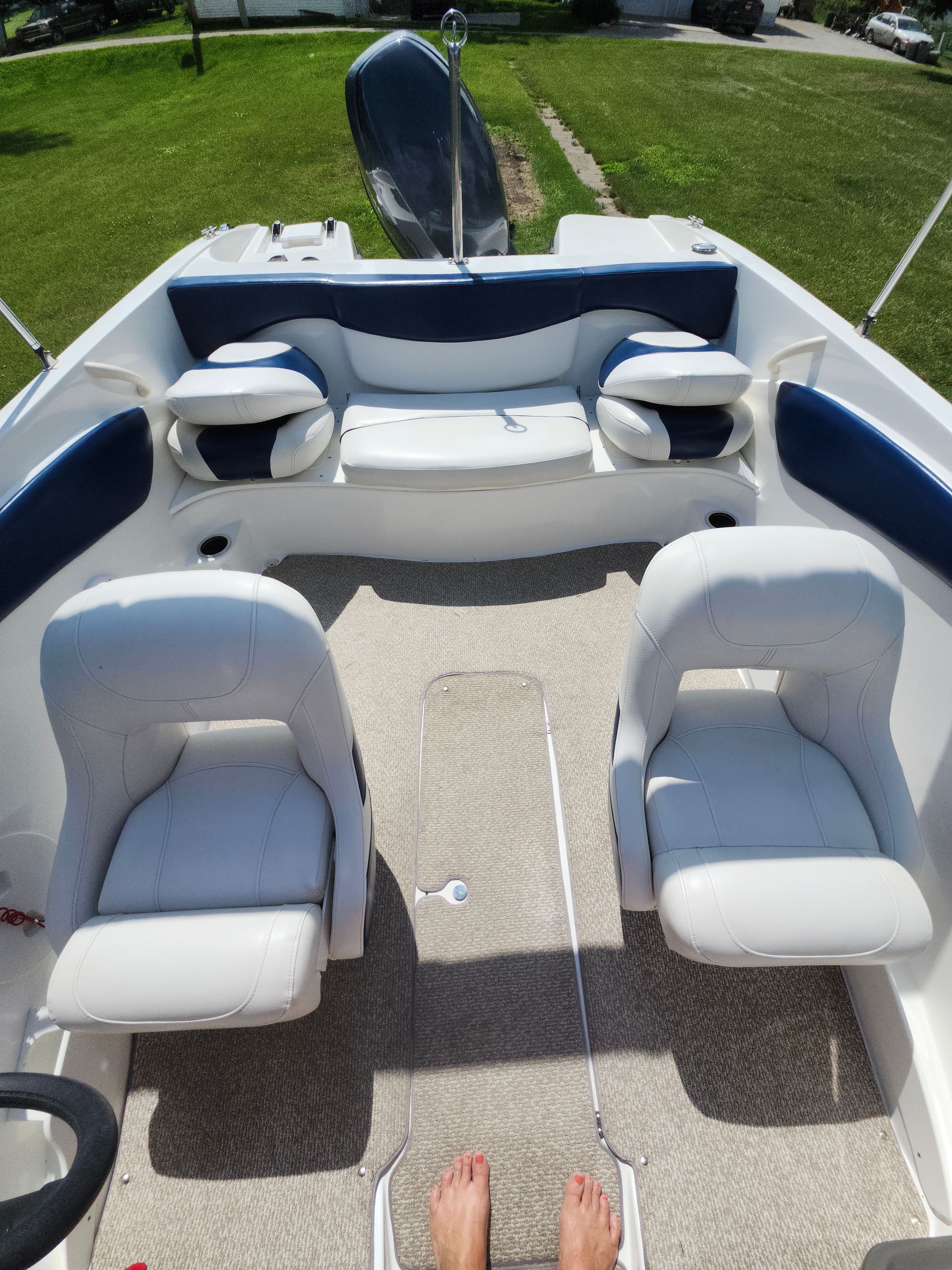 Interior view of a 2013 Rinker 186 Captiva with white and blue seating.