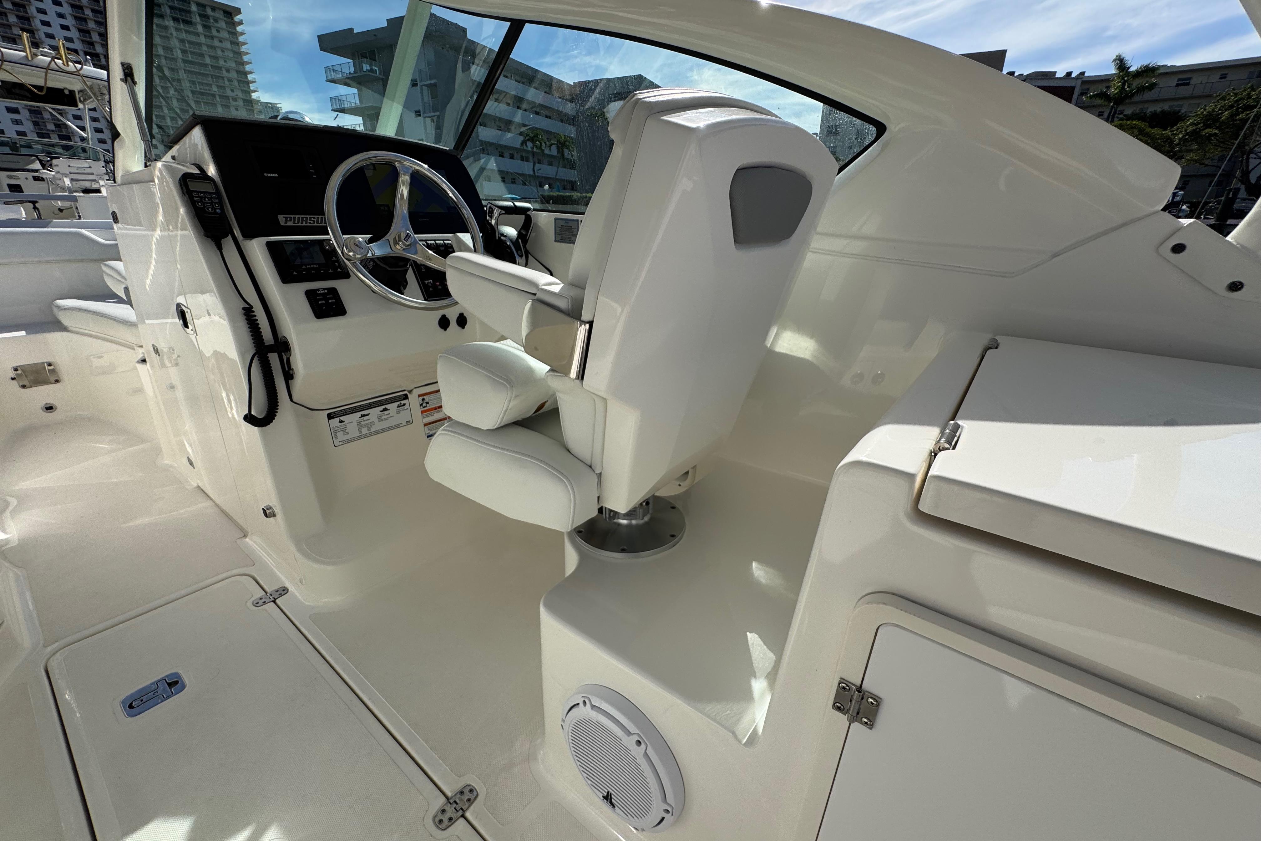 2022 Pursuit DC 266 Dual Console boat interior with steering wheel and seating.