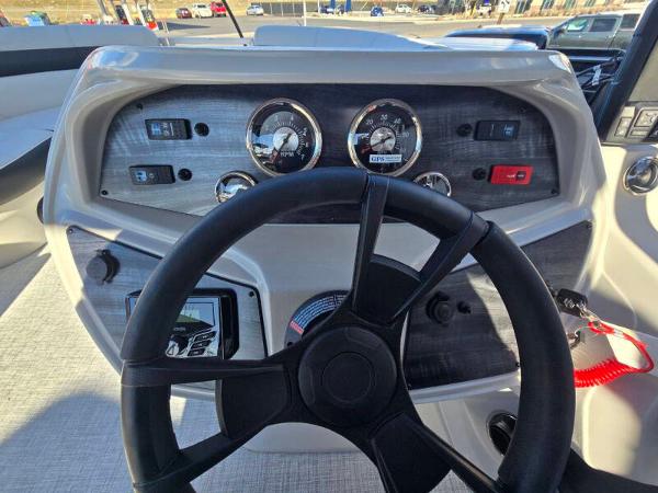 Dashboard of 2025 Berkshire 20 CL boat with steering wheel and gauges.