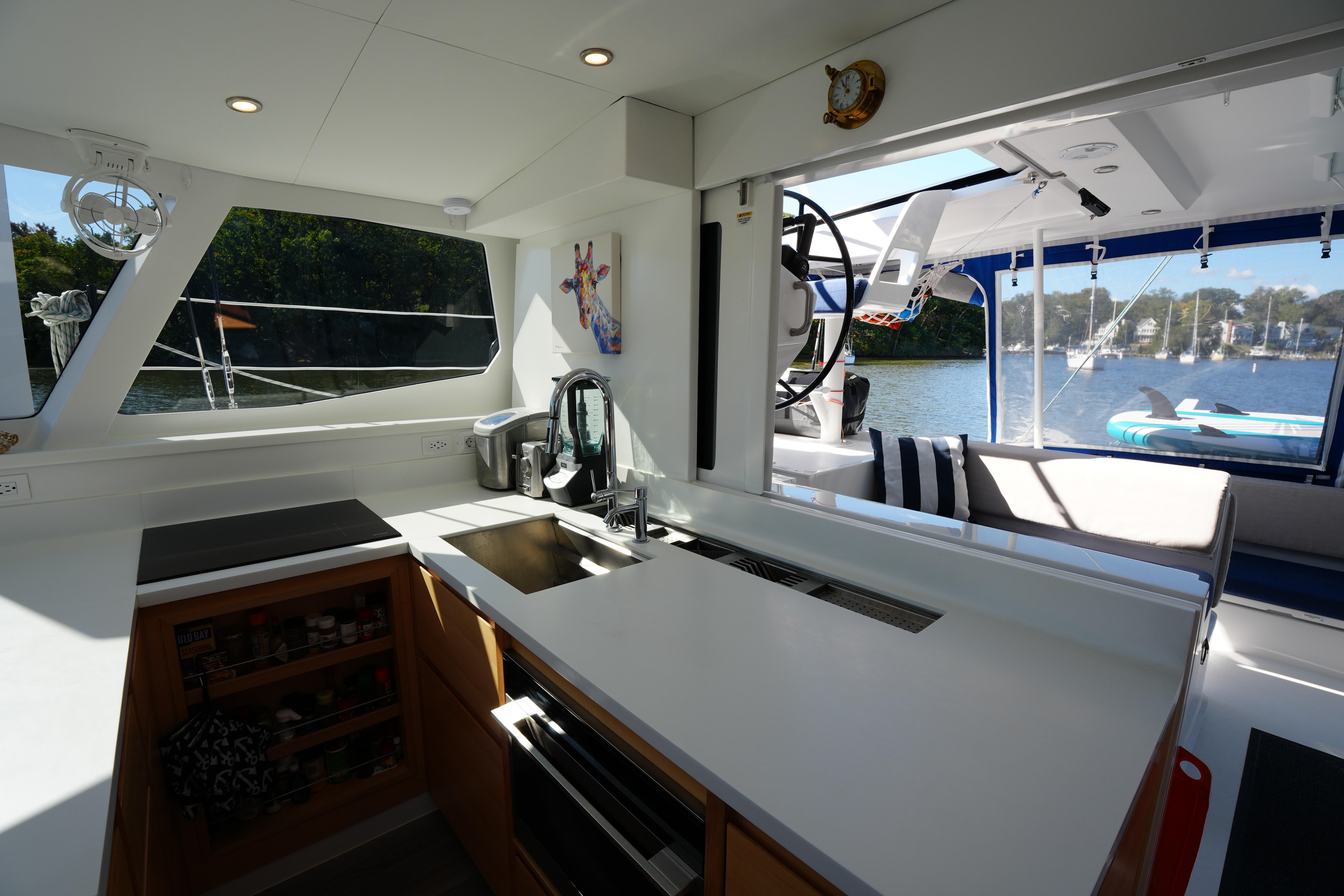 Modern kitchen interior on 2024 Balance 442 yacht with scenic water view.