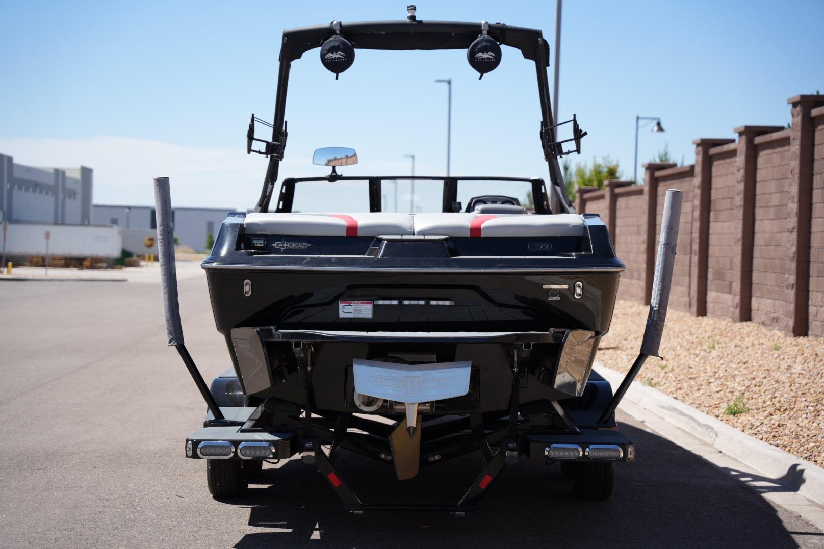 2019 Axis A22 boat rear view, parked on a sunny street.