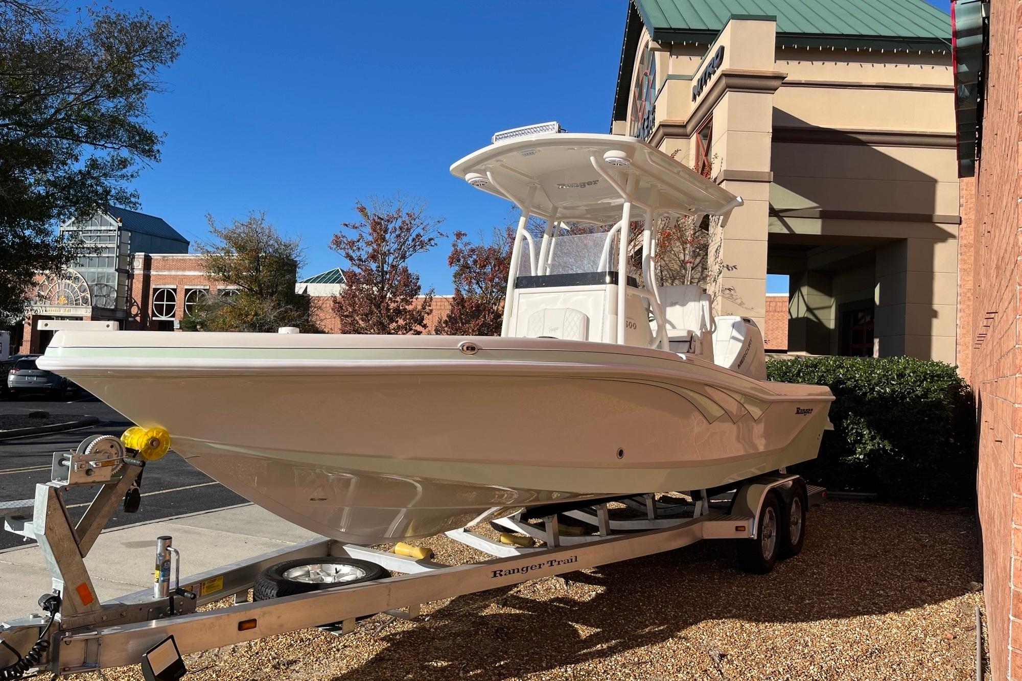 2024 Ranger 2600 Bay boat on trailer, parked outdoors near buildings.