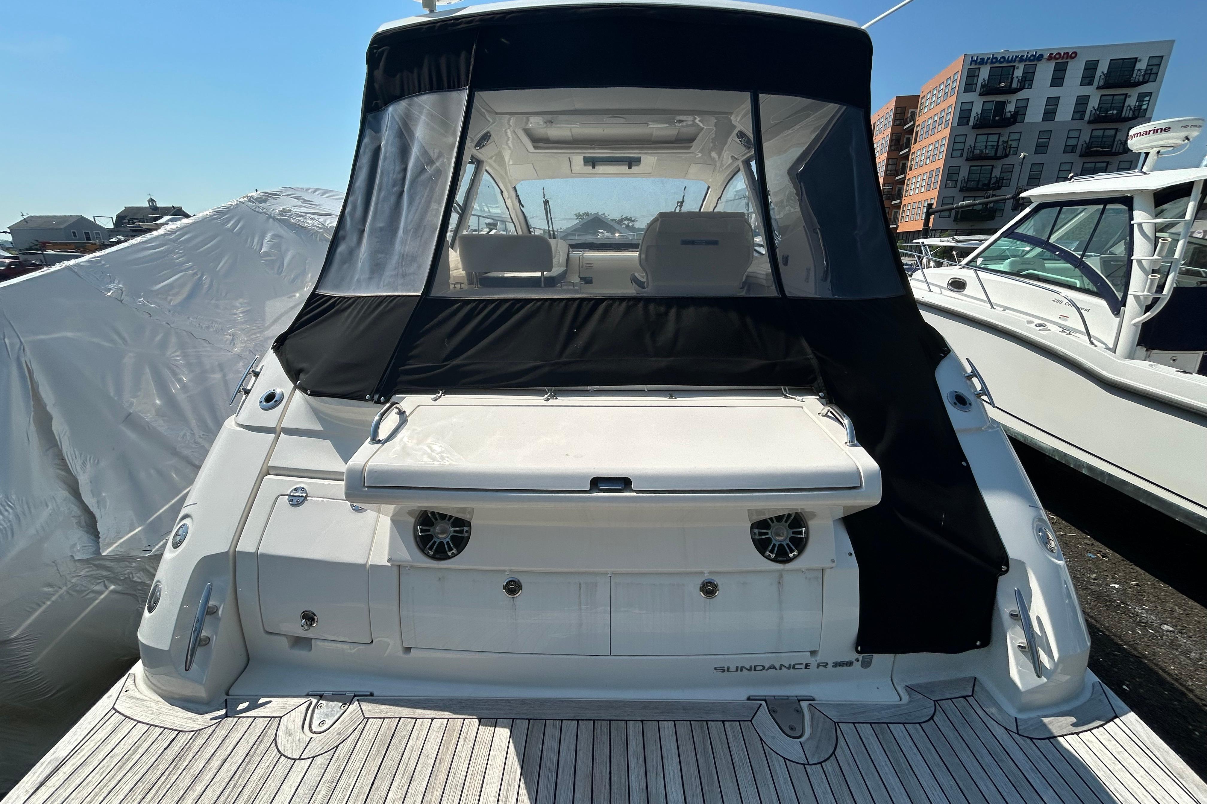 2019 Sea Ray Sundancer 350 yacht docked, rear view with covered cockpit.