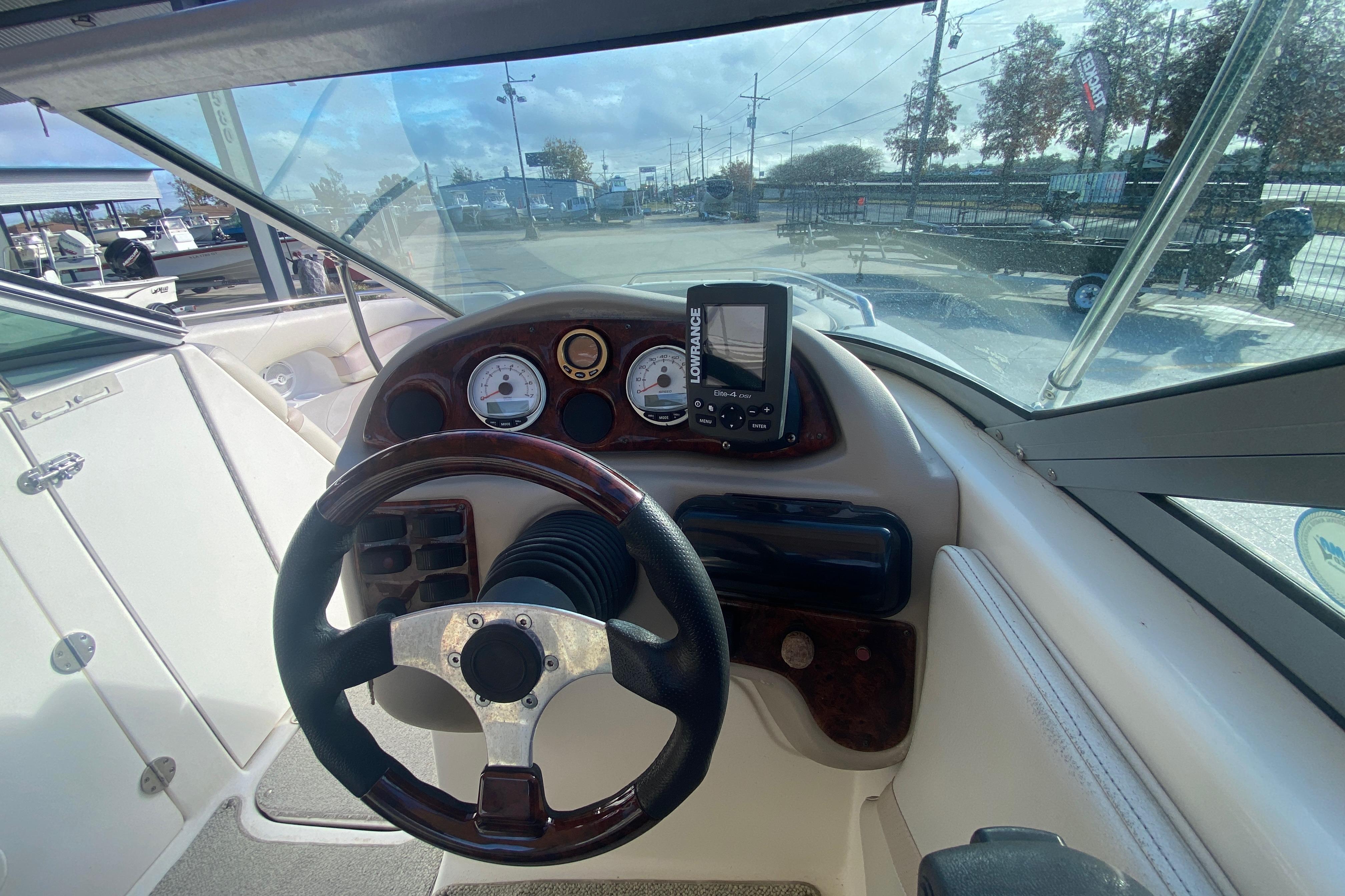 2007 NauticStar 230DC Sport Deck boat dashboard with steering wheel and navigation system.