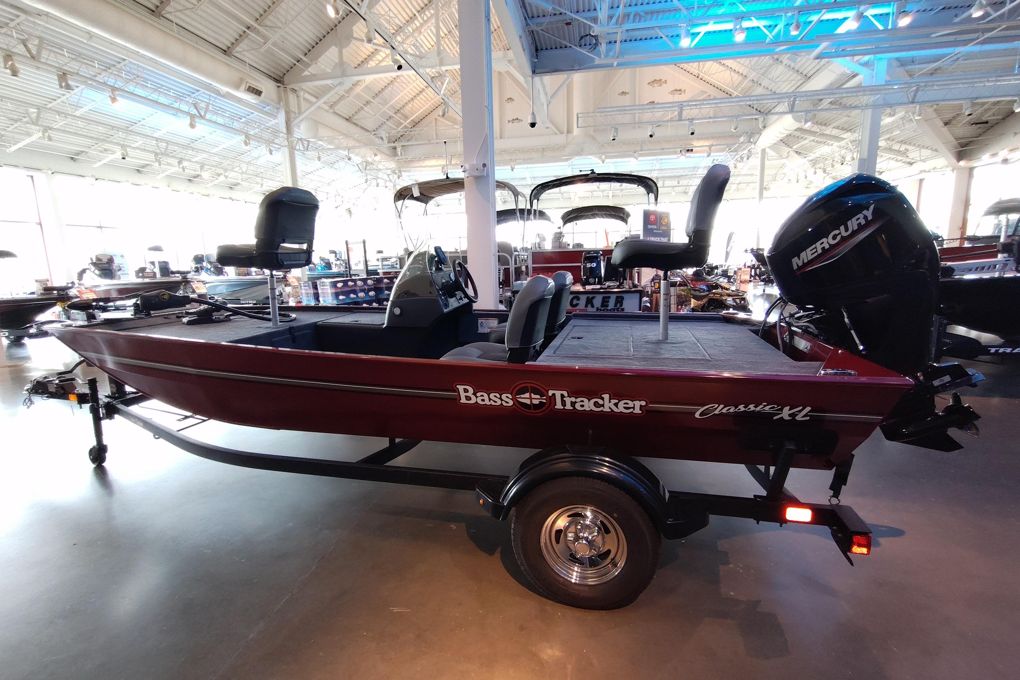 2026 Tracker Bass Tracker Classic XL boat displayed in a showroom with Mercury engine.