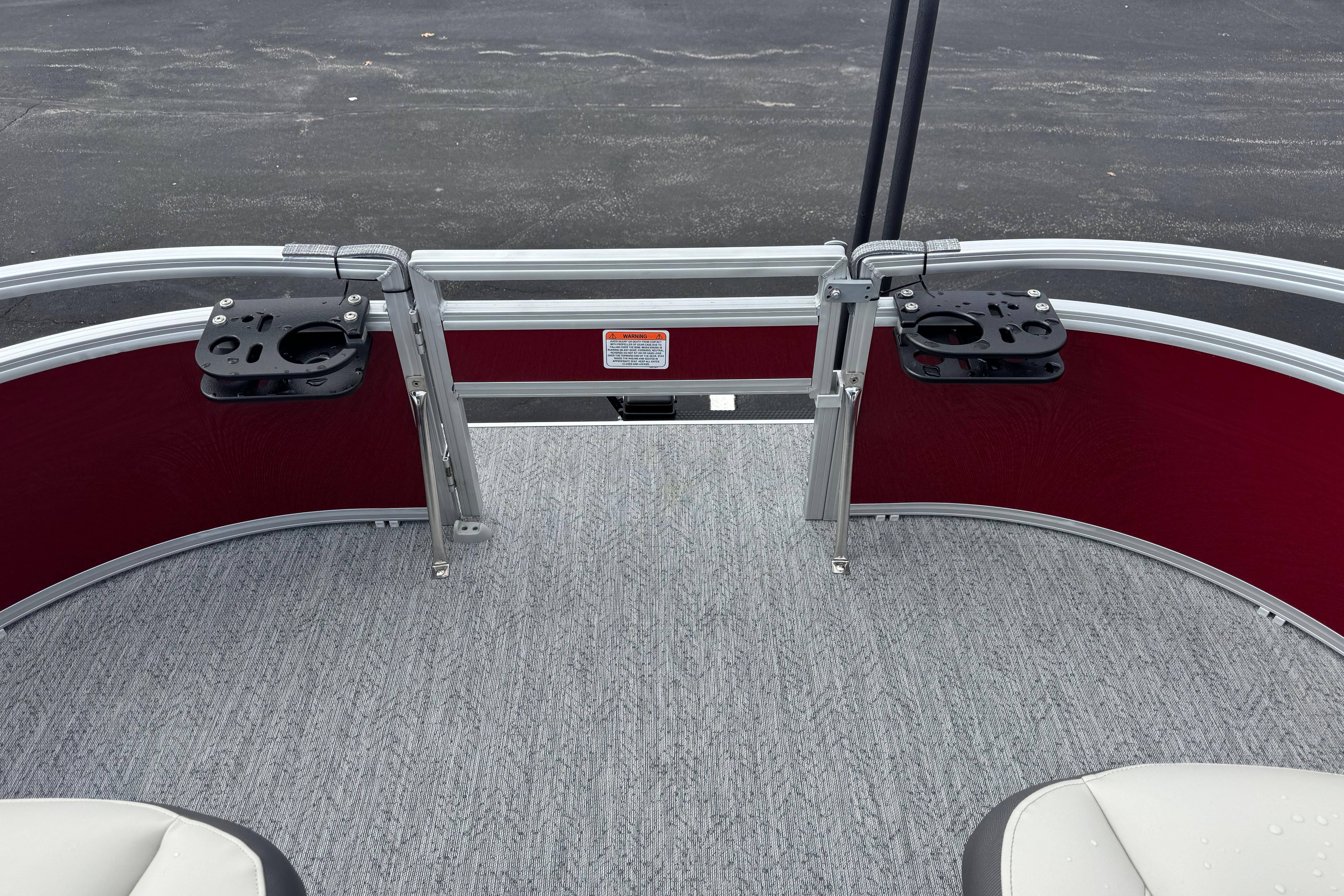 2026 Sun Tracker Bass Buggy 16 XL Select boat interior with rod holders and carpeted deck.