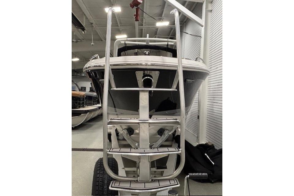 2026 Chaparral SSX 8 boat front view in showroom with ladder.