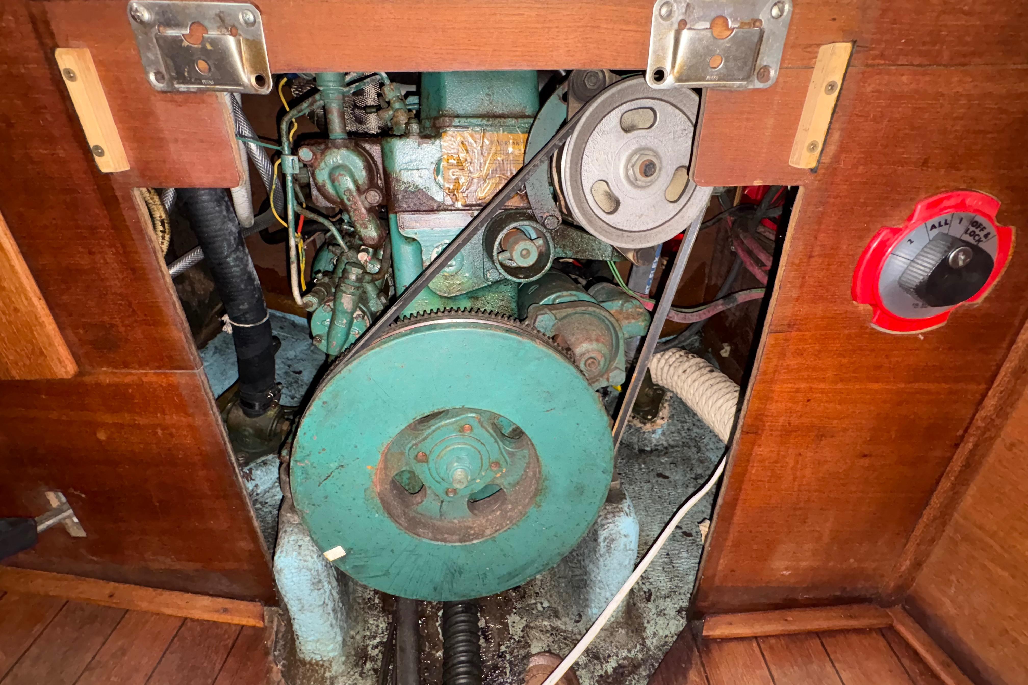 Engine compartment of a 1981 Sabre 31 sailboat, featuring a visible belt and pulley system.