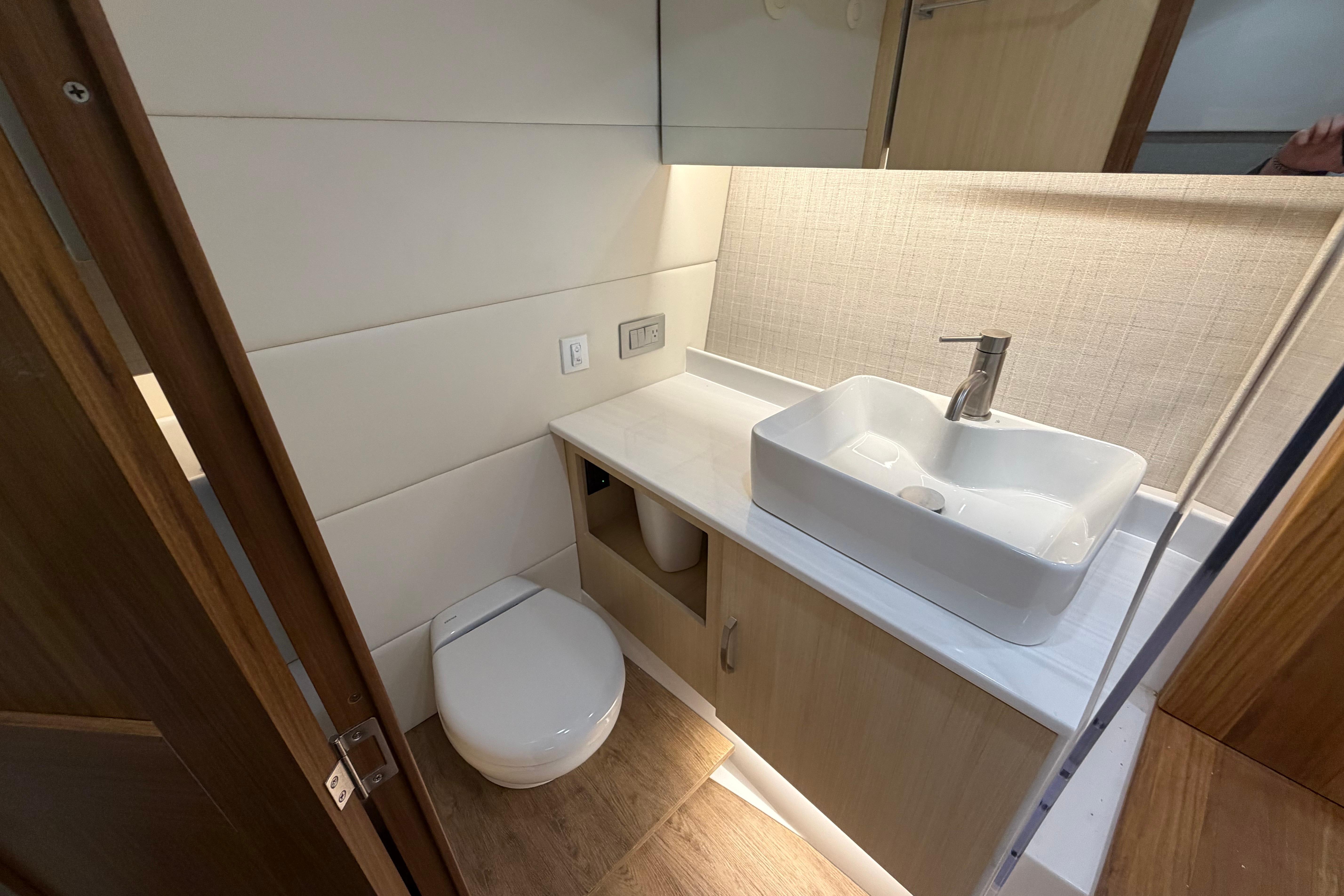 Modern bathroom in 2027 Regal 38 Surf boat with sleek sink and toilet.