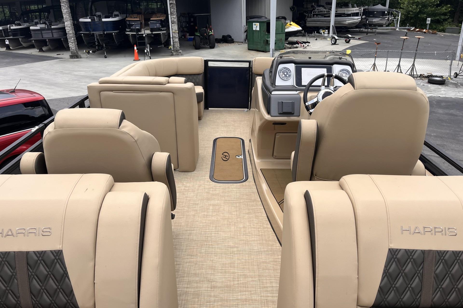 Interior view of 2022 Harris Solstice 230 CWDH pontoon boat with beige seating.