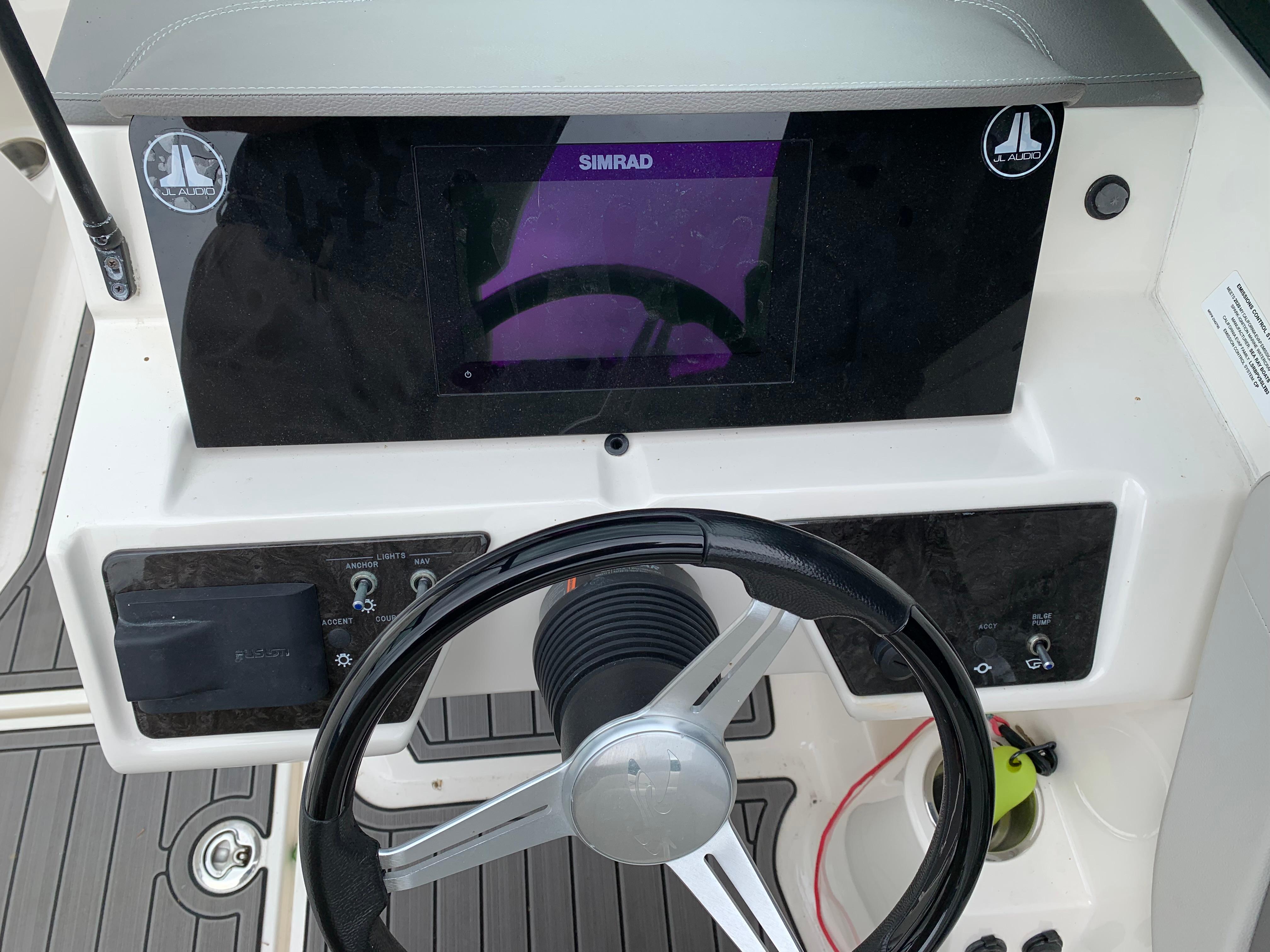 Steering console of 2020 Sea Ray SPX 190 Outboard with Simrad display and JL Audio system.
