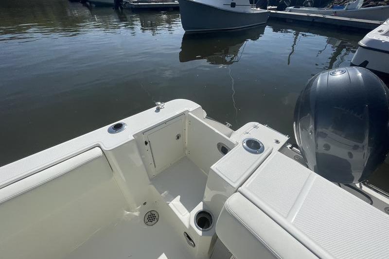 2023 Robalo R270 Center Console boat interior with seating and engine view.