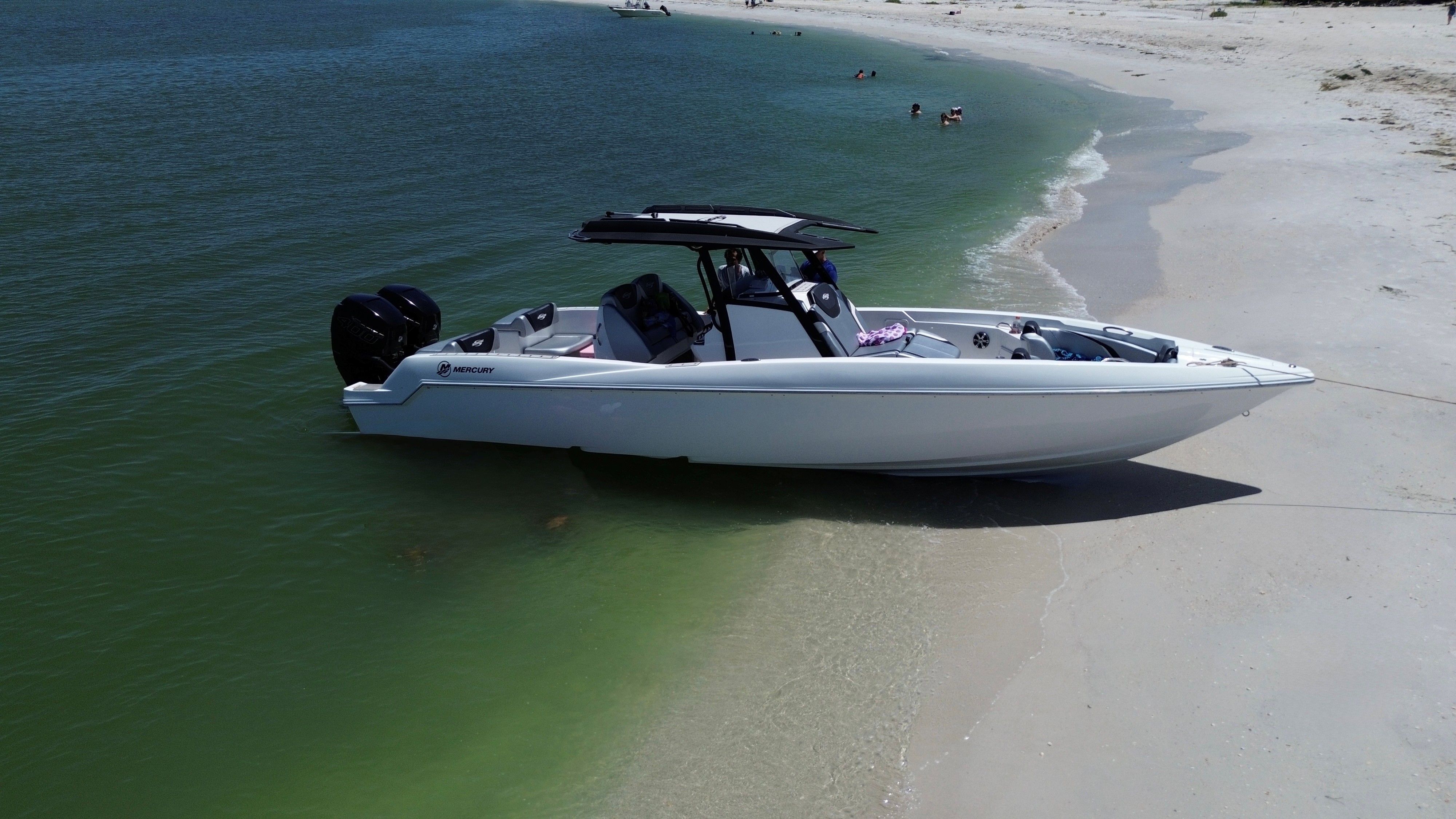 2017 Sunsation 32 CCX boat parked on sandy beach.