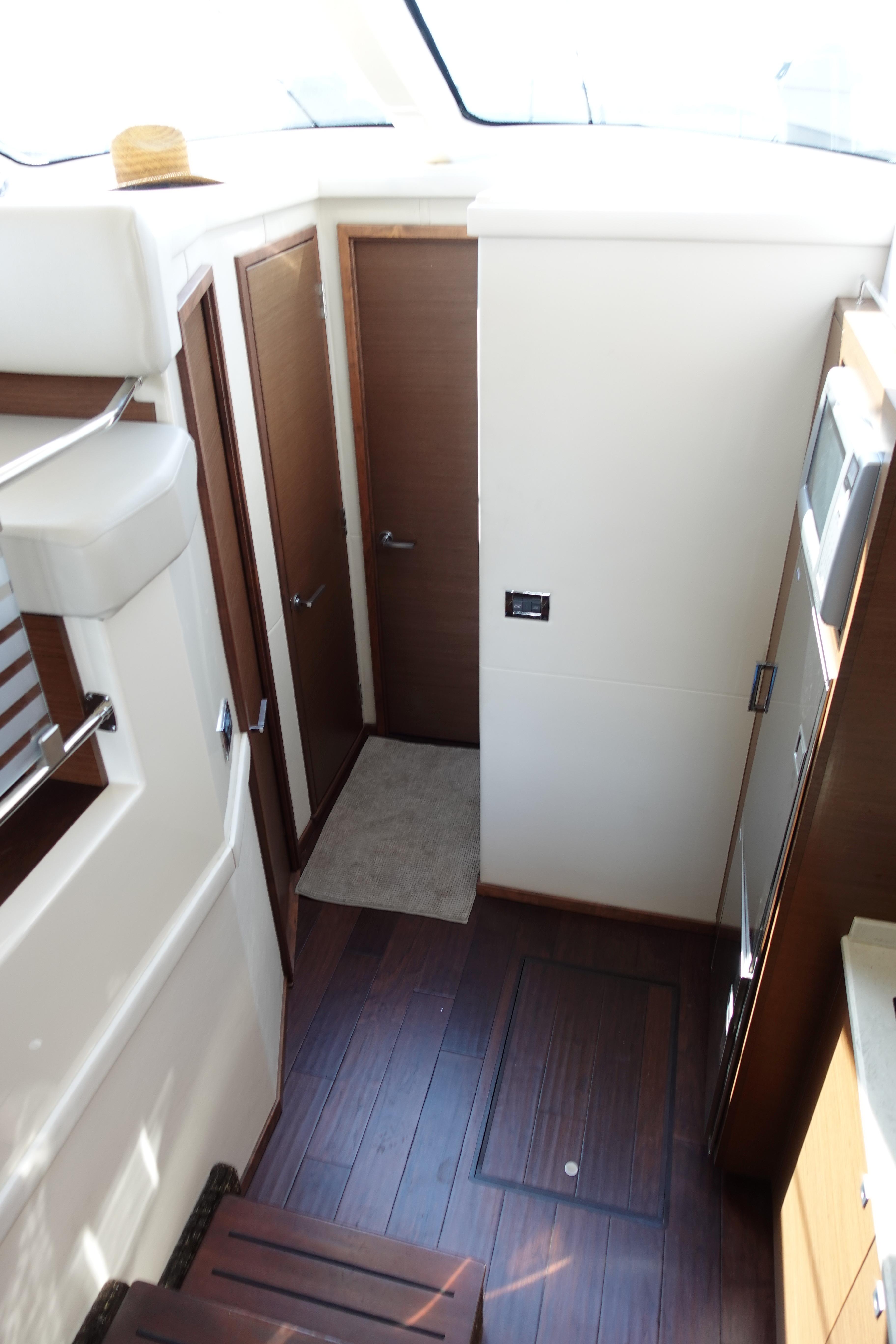 Interior view of 2012 Sea Ray 450 Sedan Bridge yacht with wooden flooring and modern design.