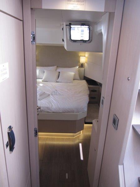 Luxurious bedroom interior of 2024 Jeanneau 60 yacht with modern design and cozy lighting.