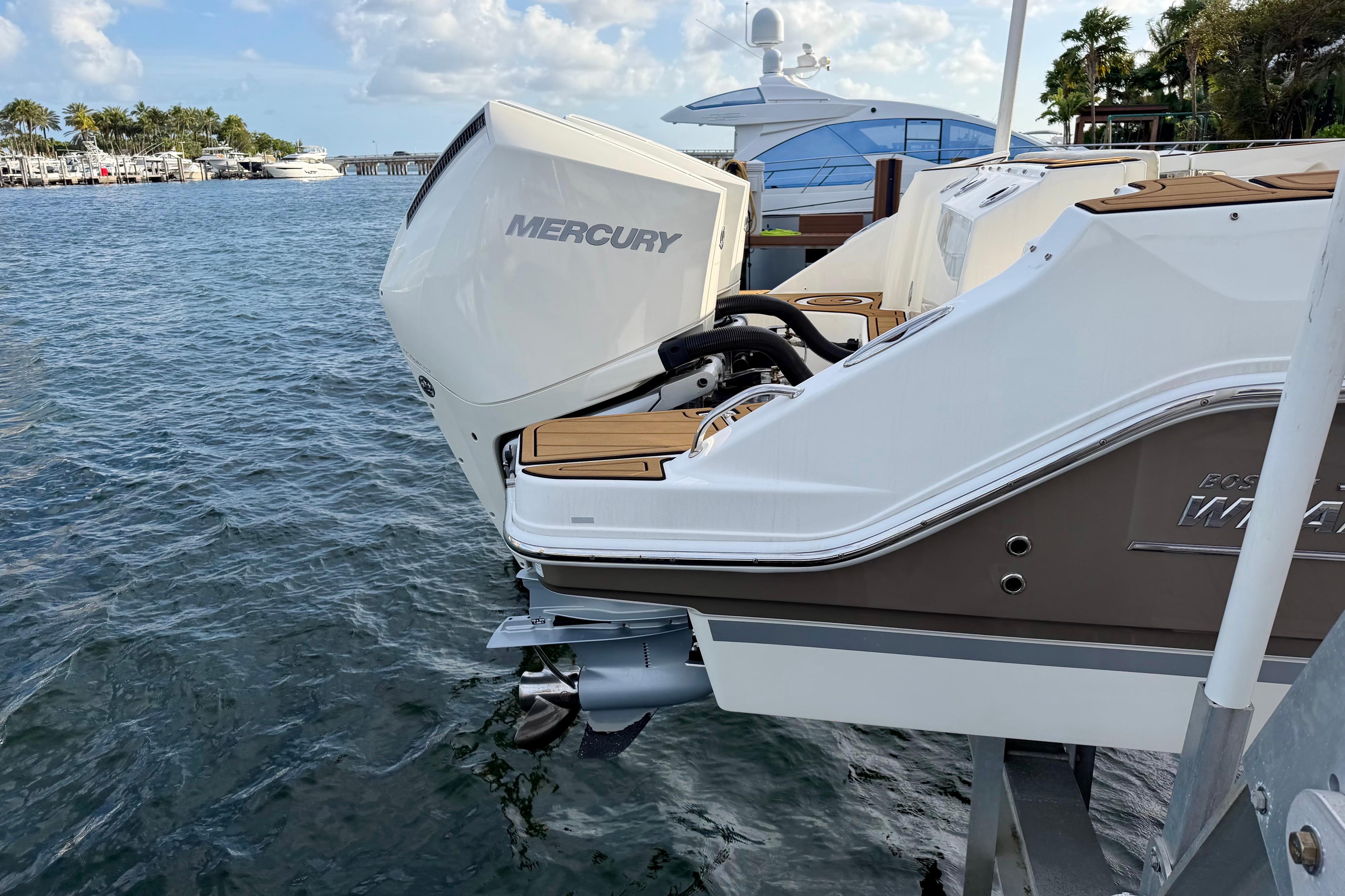 2022 Boston Whaler 280 Vantage with Mercury outboard engine docked by the water.