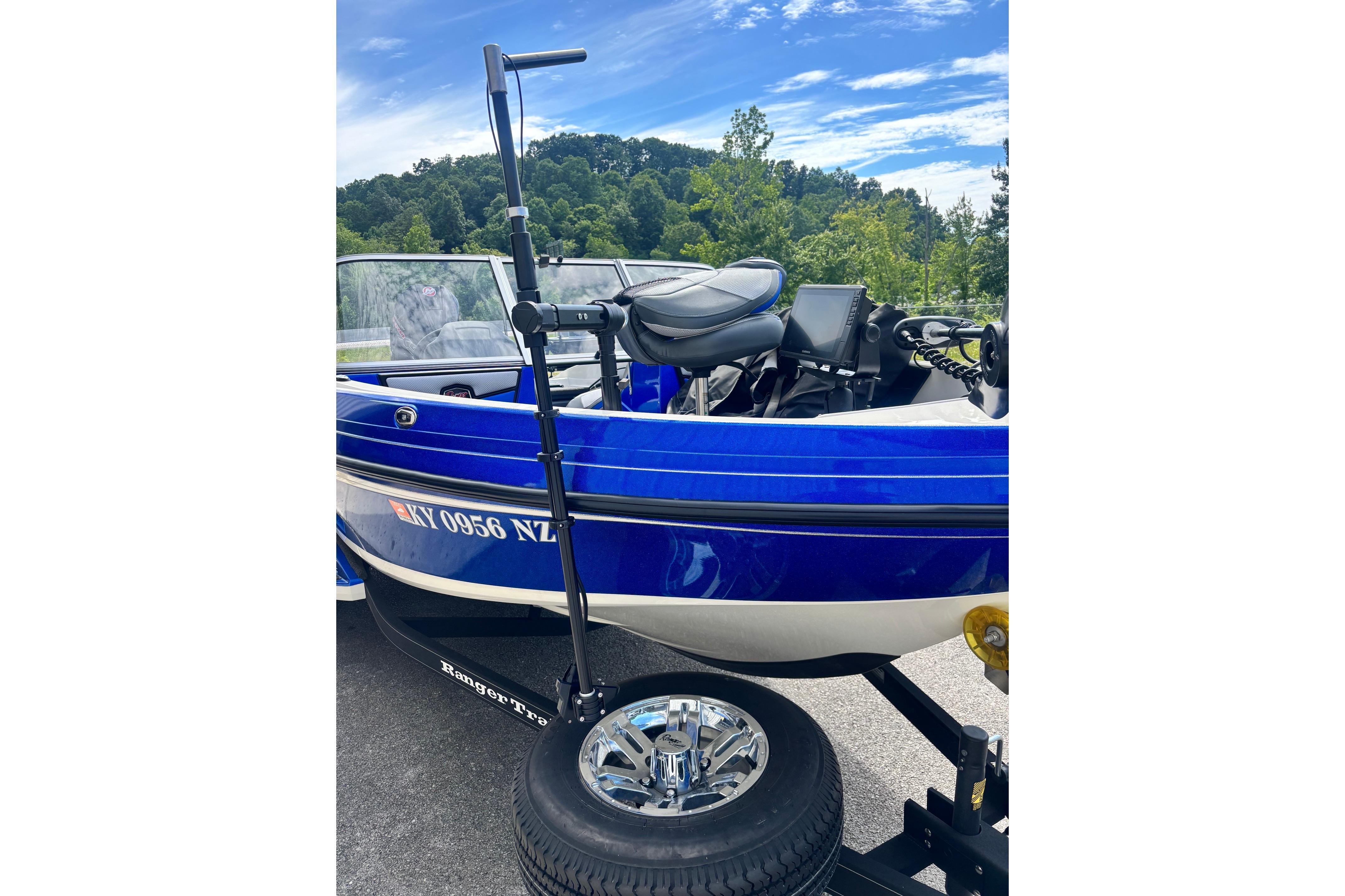 2022 Ranger 1880MS boat in vibrant blue, parked with scenic forest backdrop.