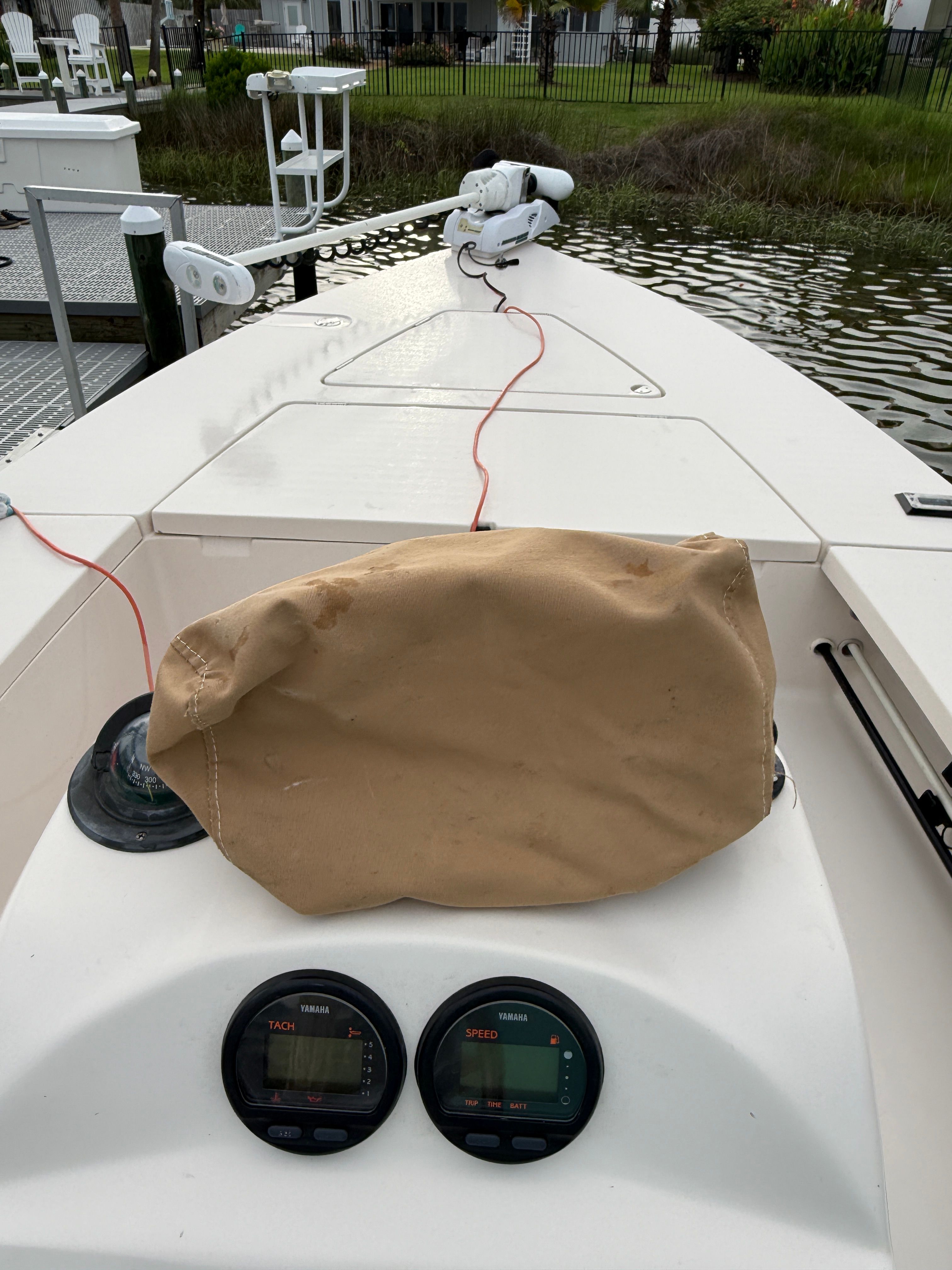 The 2003 Maverick 18 boat is docked. It features a simple deck and instruments.