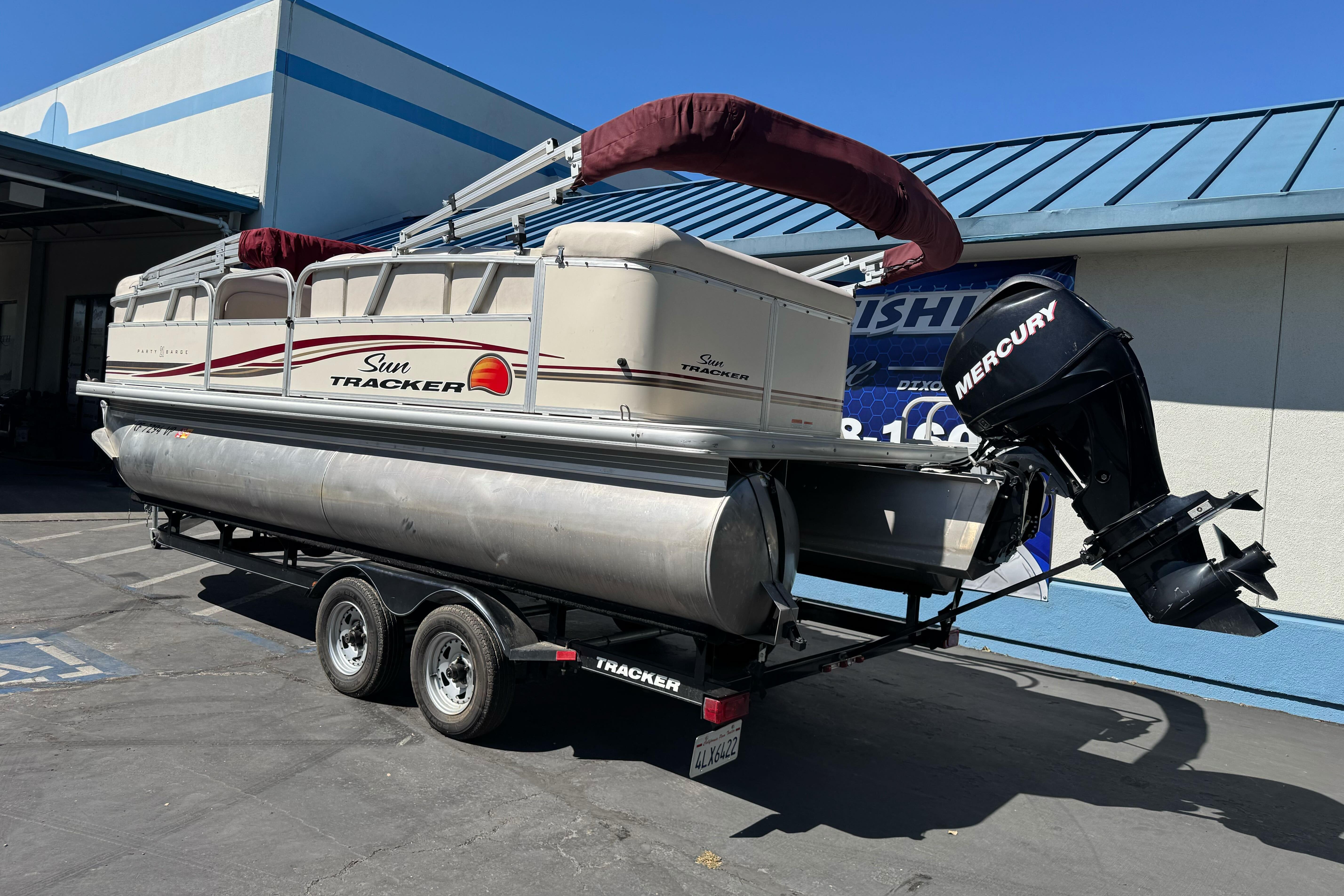 2011 Sun Tracker Party Barge 21 pontoon boat on trailer with Mercury outboard motor.