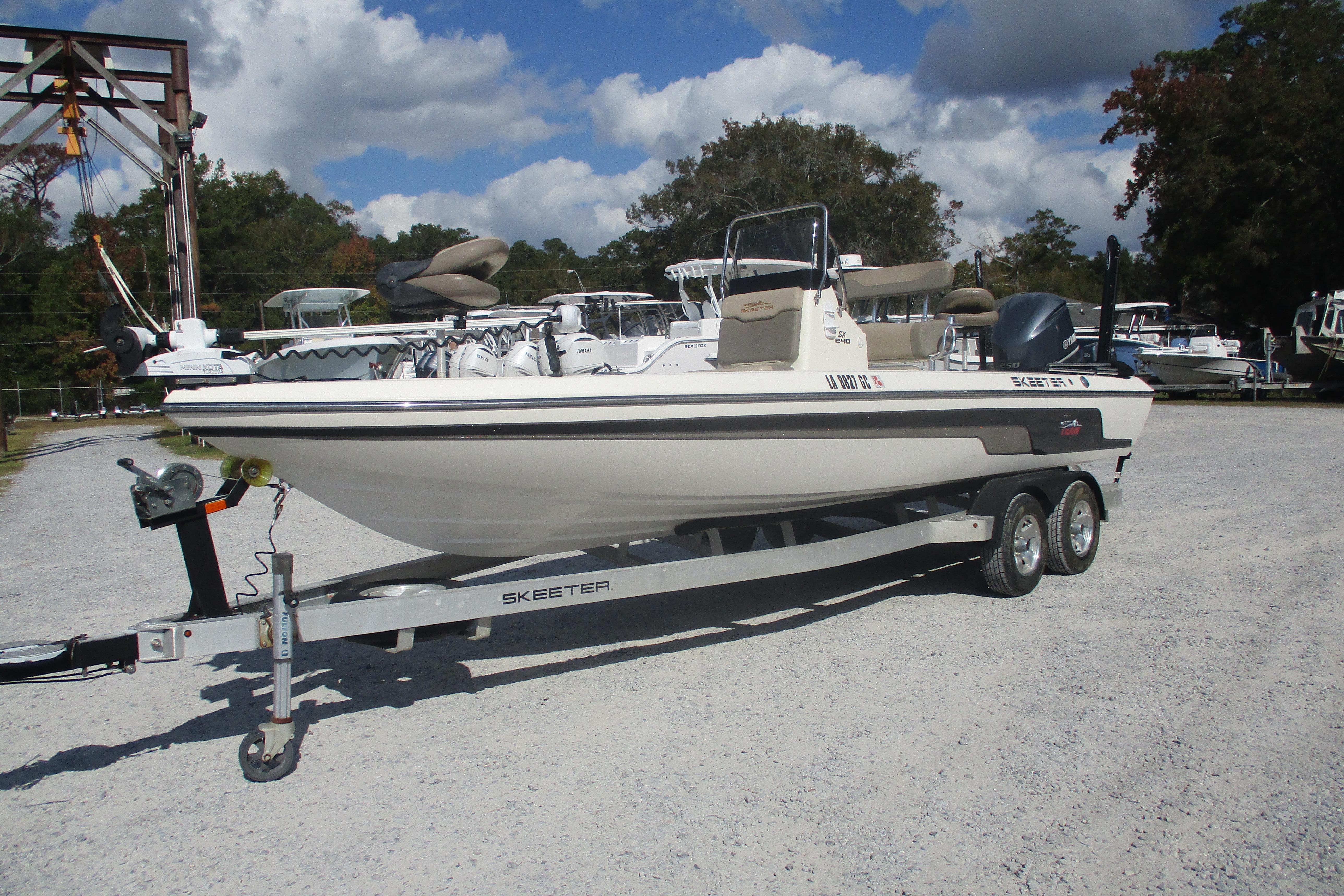 2014 Skeeter SX240 boat on trailer in outdoor setting.