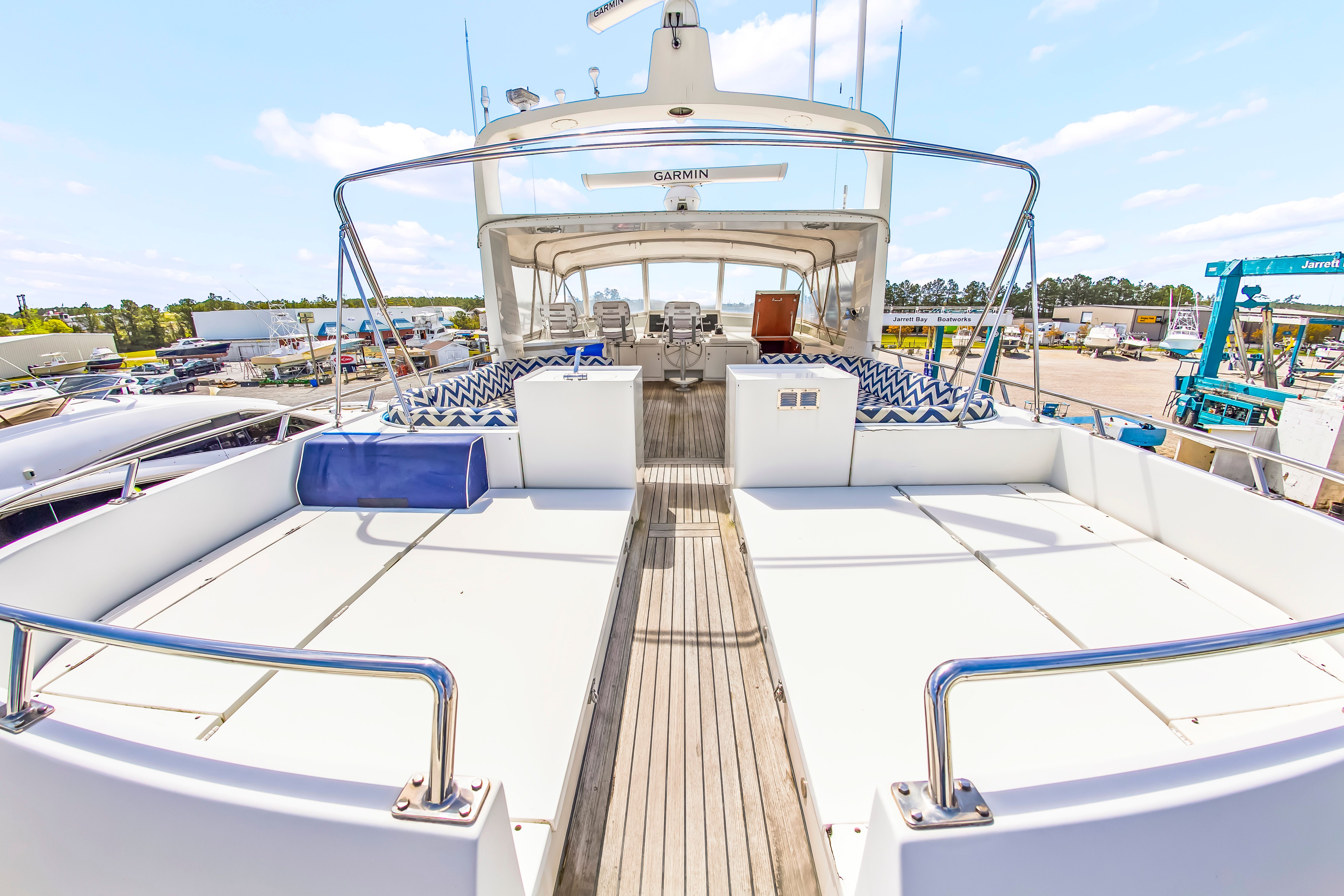 The image shows the deck of a 1987 Jongert 78 Motor Yacht with elegant seating areas.