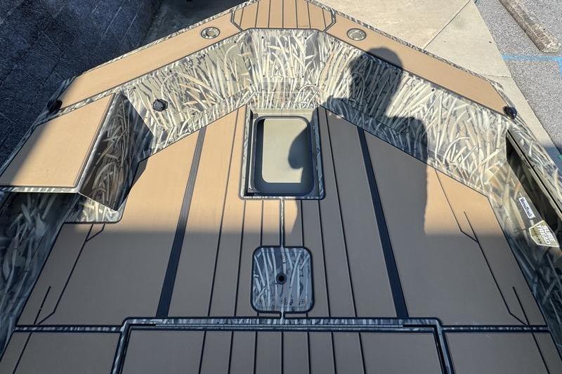 2026 Tracker Grizzly 1756 T Marsh boat interior with camouflage design and storage compartments.