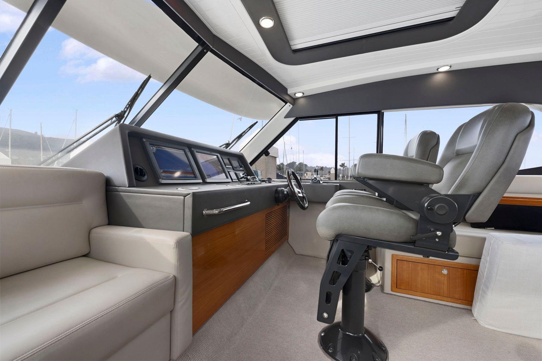 Luxurious interior of 2014 Maritimo M50 yacht with modern helm and seating.