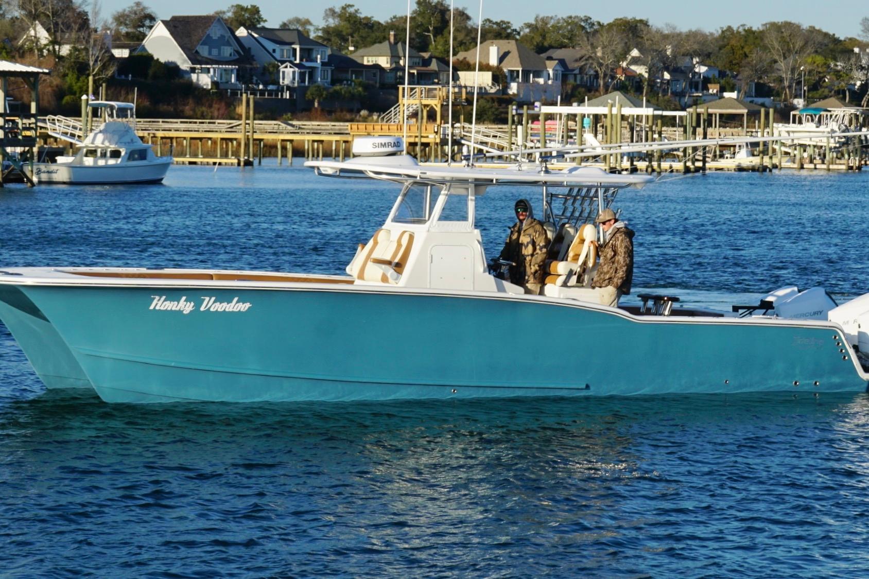 2022 Tideline 365 Offshore boat on water, with two people onboard.