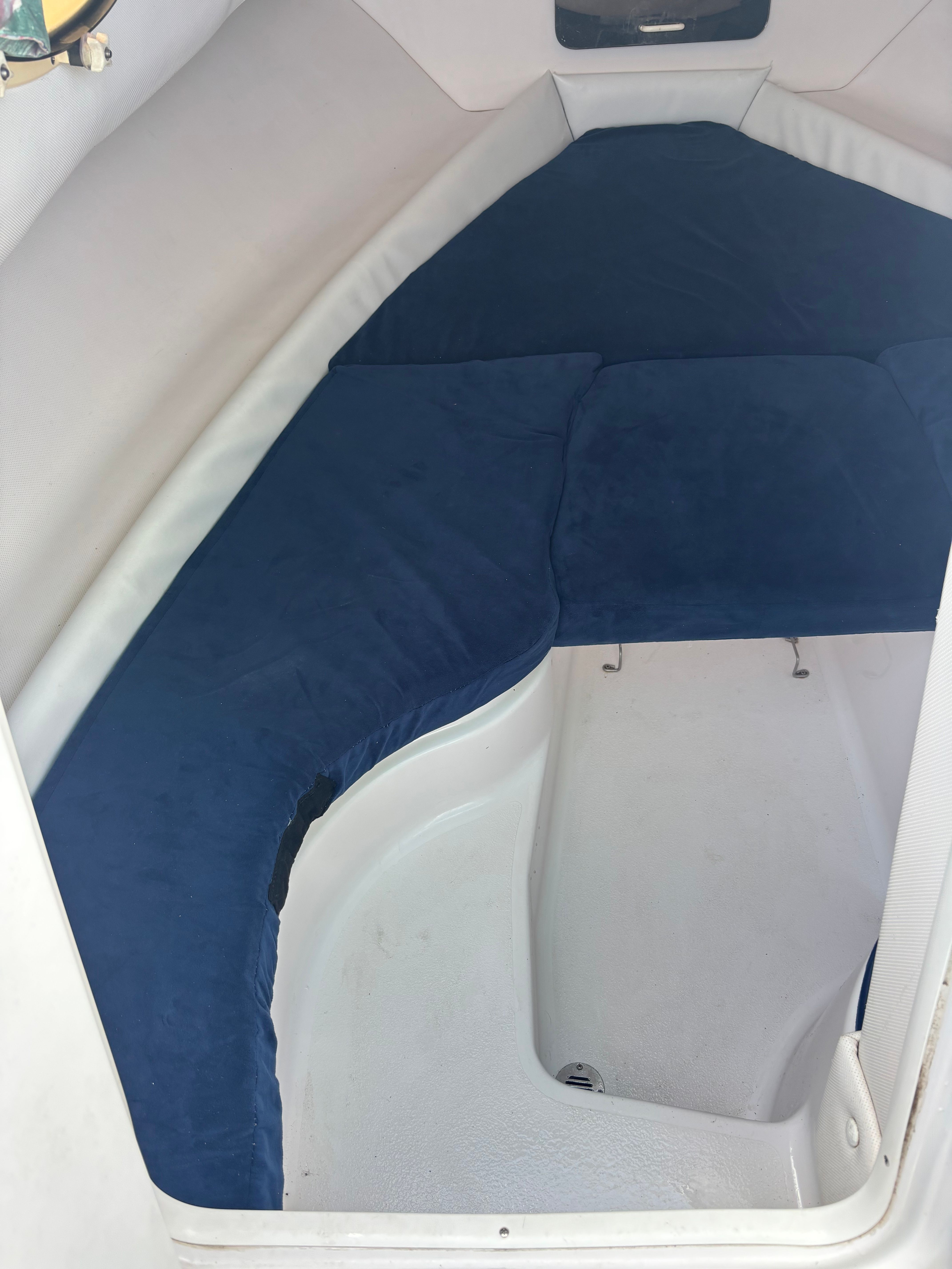 Interior of a 1999 Pro-Line 221 Walk Around with blue cushions.